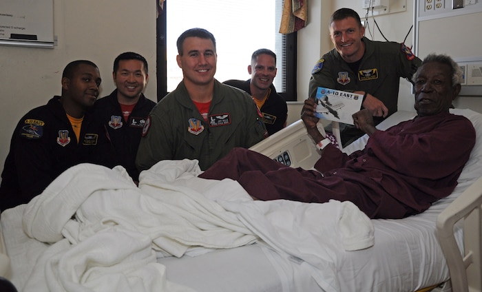 Members of the A-10 and F-15E demonstration teams visit a patient at the Ralph H. Johnson Veterans Affairs Medical Center, April 7, in Charleston, S.C. The demonstration teams participated in the 2011 Air Expo at Joint Base Charleston, S.C., April 9.  (U.S. Air Force photo/Staff Sgt. Darren Ellis)