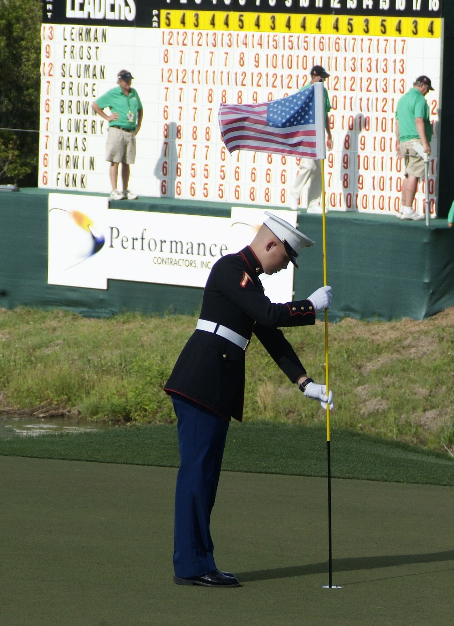 Pfc. Zack Johanson, Keesler Marine Corps Detachment, replaces the flag on Hole 18 after a putt during Sunday’s final round.  (U.S. Air Force photo by Jamey Foster)