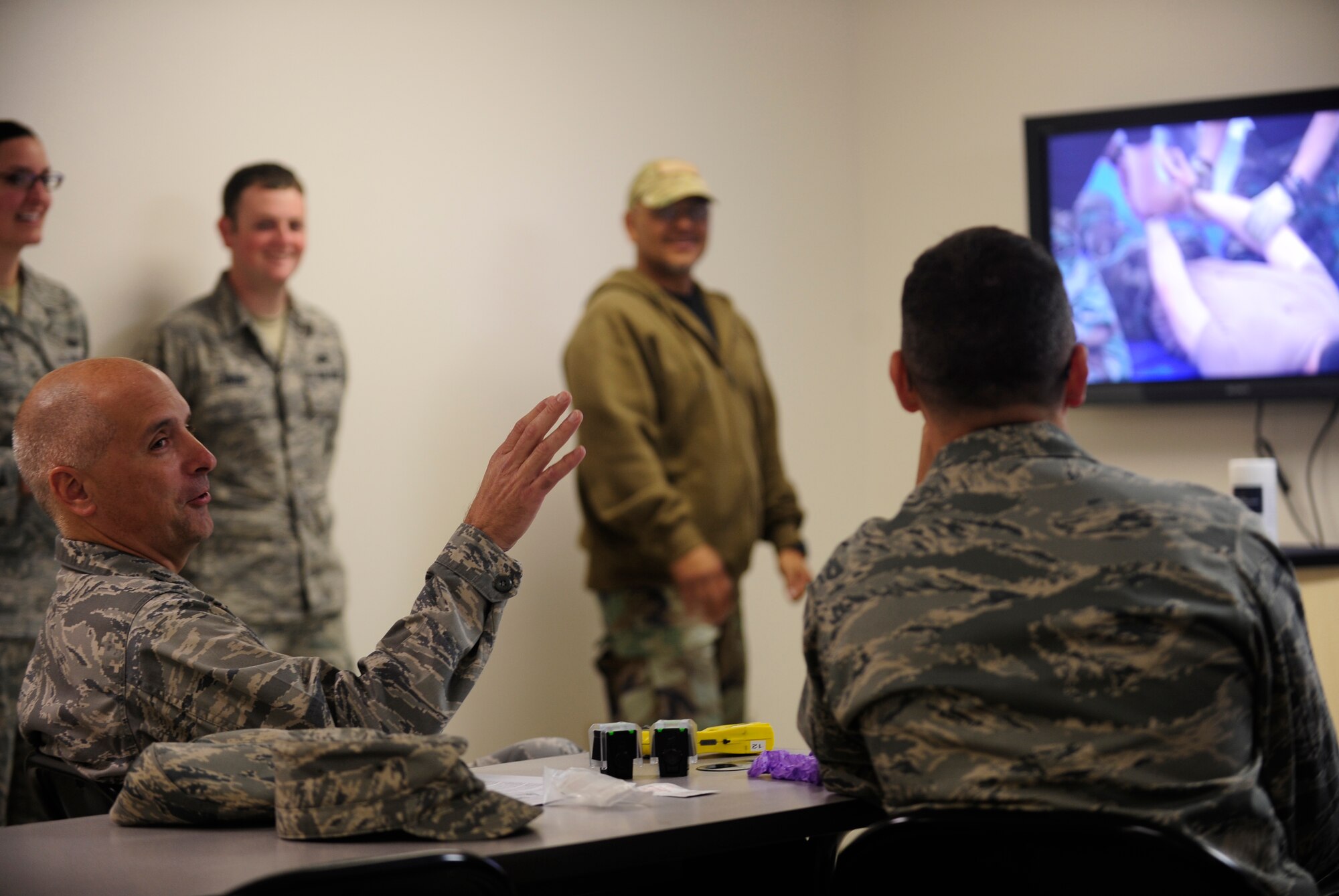 VANDENBERG AIR FORCE BASE, Calif. -- Col. Richard Boltz, the 30th Space Wing commander, and Col. Keith Balts, the 30th Space Wing vice commander, sit in for a demonstration and proper use of a Taser X26 Electronic Control Device at the 30th Security Forces Squadron training center here Thursday, April 7, 2011.  The commanders personally experienced the device's restraining power during a live demonstration. (U.S. Air Force photo/Staff Sgt. Andrew Satran) 
