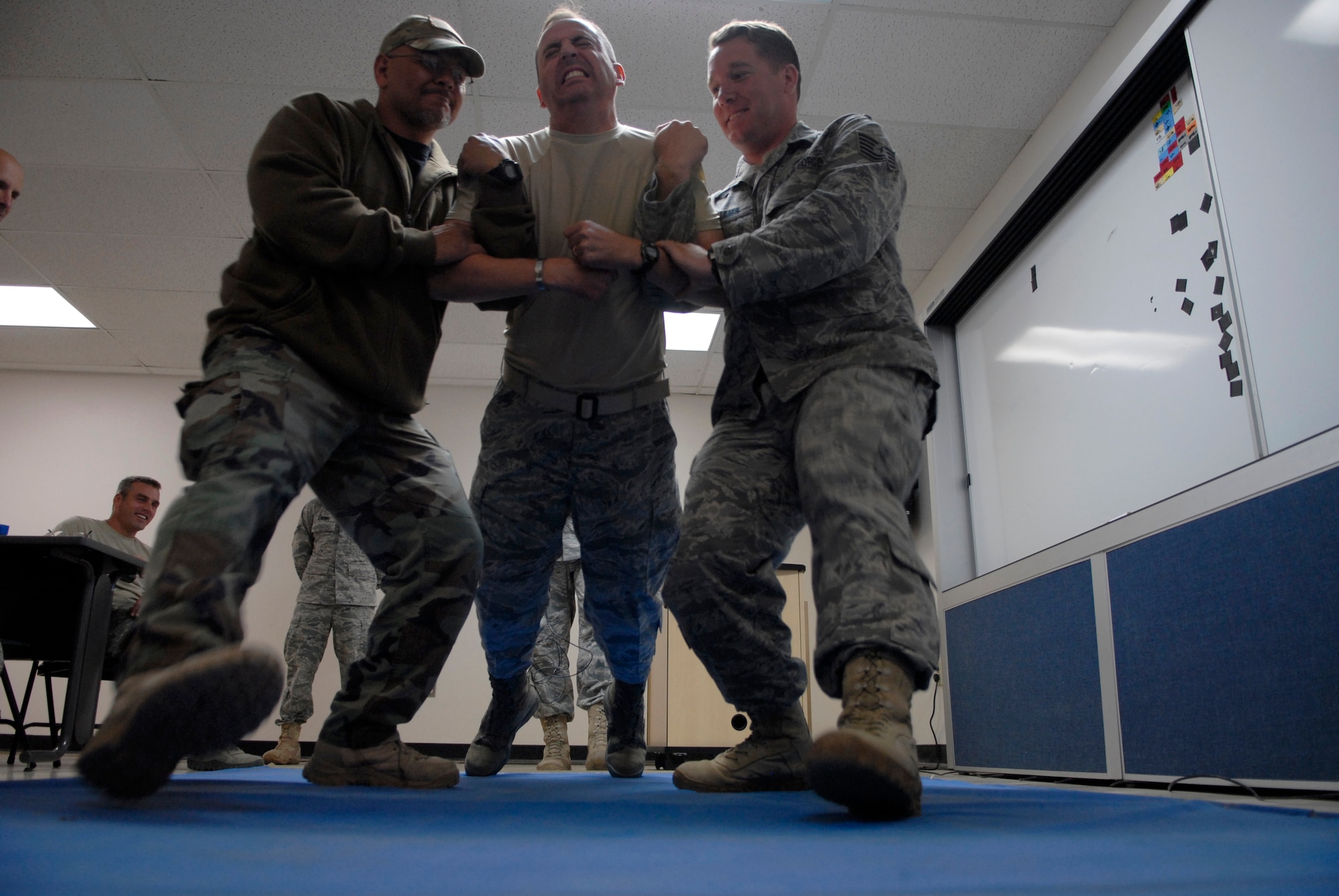 VANDENBERG AIR FORCE BASE, Calif. -- Feeling charged up, Col. Keith Balts, the 30th Space Wing vice commander, gets a taste of the Taser X26 Electronic Control Device at the 30th Security Forces Squadron training center here Thursday, April 7, 2011.  The training was provided to the 30th Space Wing leadership for educational purposes regarding the non-lethal weapon's capabilities when used by 30th SFS members.  (U.S. Air Force photo/Staff Sgt. Andrew Satran) 
