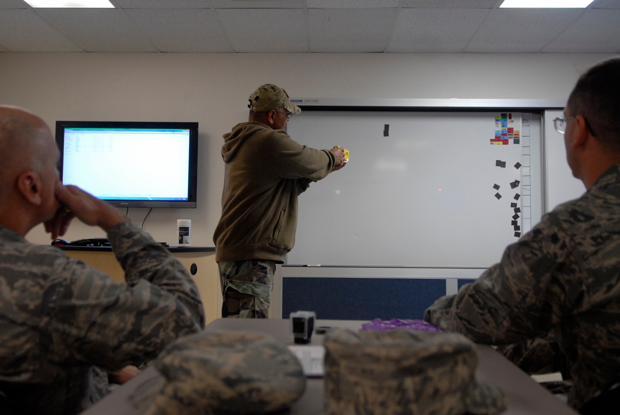 VANDENBERG AIR FORCE BASE, Calif. -- Christopher Baltazar, a 30th Security Forces Squadron training manager, demonstrates proper use of a Taser X26 Electronic Control Device at the 30th SFS training center here Thursday, April 7, 2011.  The training was provided to the 30th Space Wing leadership for educational purposes regarding the non-lethal weapon's capabilities when used by 30th SFS members.  (U.S. Air Force photo/Staff Sgt. Andrew Satran) 

