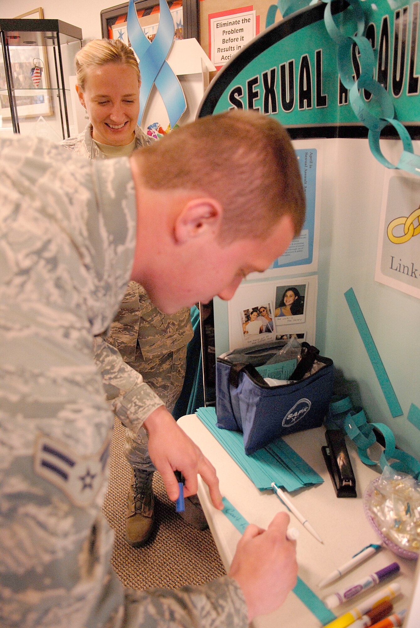 VANDENBERG AIR FORCE BASE, Calif. -- Airman 1st Class Gusttavo Behrens, a 30th Medical Operations Squadron bio-environmental technician, writes inspirational words at the dining facility in support of Sexual Assault Awareness Month here Thursday, April 7, 2011.  The Sexual Assault Prevention and Response office displayed their message to help Team V members gain awareness toward preventing future sexual assaults from occurring.  (U.S. Air Force photo/Staff Sgt. Andrew Satran) 

  