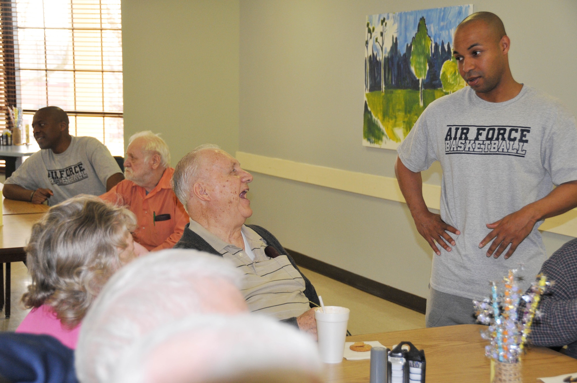 Kurtis Darden, Air Force Basketball Team coach, talks with residents of the Minnesota Veterans Home after training camp April 7.  Darden is an Air Force Reserve captain assigned to the 440th Airlift Wing at Ft. Bragg/Pope AFB, N.C. The team is conducting training camp at Minneapolis-St. Paul Air Reserve Station before heading for the all service championship in San Diego, Calif. later in the week. (Air Force Photo/Paul Zadach)