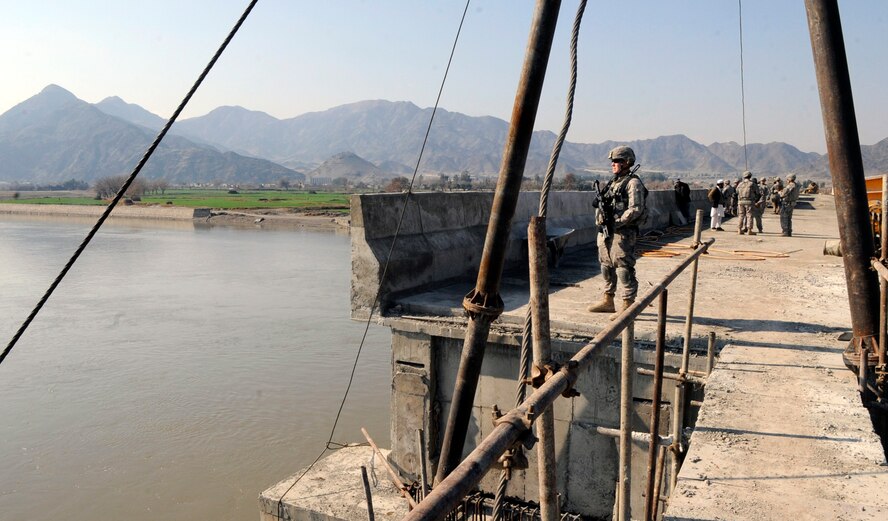 NANGARHAR PROVINCE, Afghanistan-- Then-Staff Sgt. Jason Zollman, Nangarhar Provincial Reconstruction Team mechanic from Waterville, Wash., pulls security on Lal Pur Bridge as a quality control check is performed during a revisit
15 Feb. The technical sergeant is deployed from Moody Air Force Base, Ga., and maintains a fleet of 17 vehicles that regularly go outside the wire. (U.S. Air Force photo/Staff Sgt. Scottie McCord)(RELEASED)