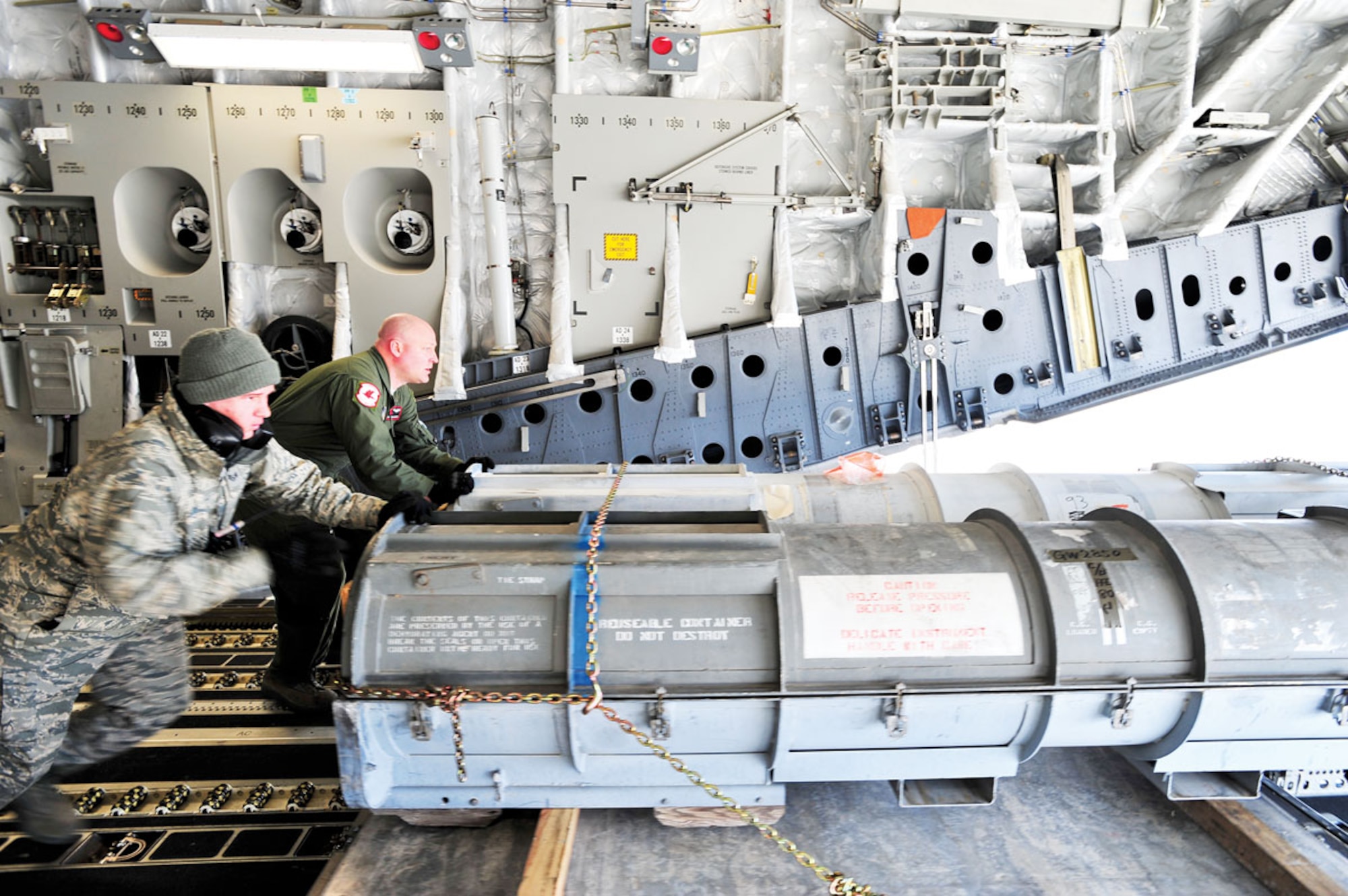 Air Force Staff Sgt. Christopher Wilkinson, 621st Contingency Responce Wing, and Technical Sgt. Travis Duxsbury, a loadmaster with the 517th Airlift Squadron, offload cargo at Misawa Air Base, Japan, April 1. (U.S. Air Force photo/Staff Sgt. Joshua Garcia)