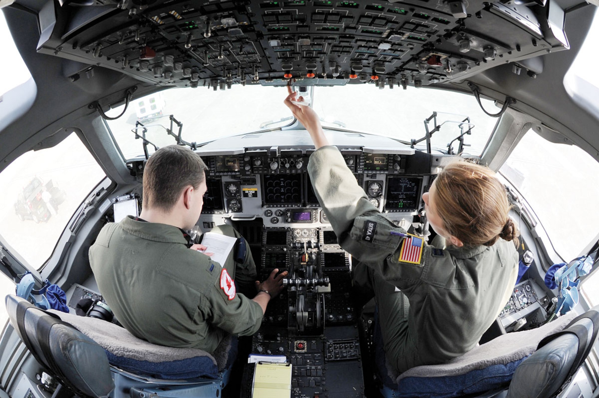 1st Lt JohnRoss Wendler and Captain Meghan Fridley-Geiger, pilots with the 517th Airlift Squadron, preflight a C-17 Globemaster III to take off at Misawa Air Base, Japan, April 1. Wendler and Fridley-Geiger along with other 517th AS crews provide support to Operation Tamodachi transporting supplies to and from Yokota Air Base, Japan. (U.S. Air Force photo/Staff Sgt. Joshua Garcia)