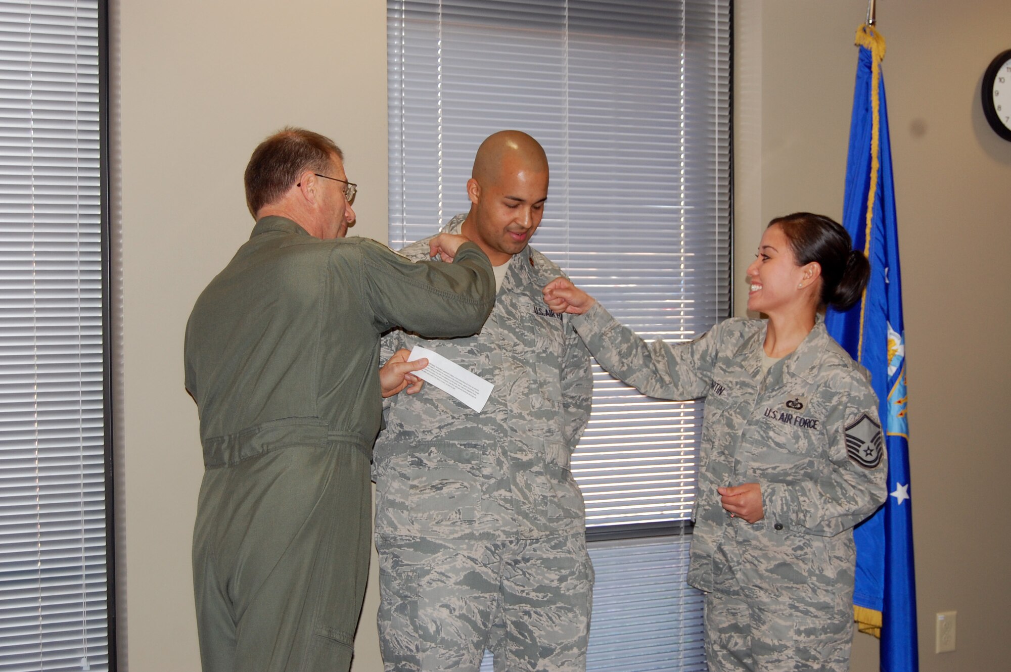NELLIS AIR FORCE BASE, Nev. -- (Center) Maj. Ricardo Martin, 926th Group executive officer, is pinned on by his wife, Master Sgt. MaryAnn Martin, 706th Fighter Squadron superintendent, and Col. Herman Brunke, Jr., 926th Group commander, during a ceremony here April 1. (U.S. Air Force photo/Capt. Jessica Martin)