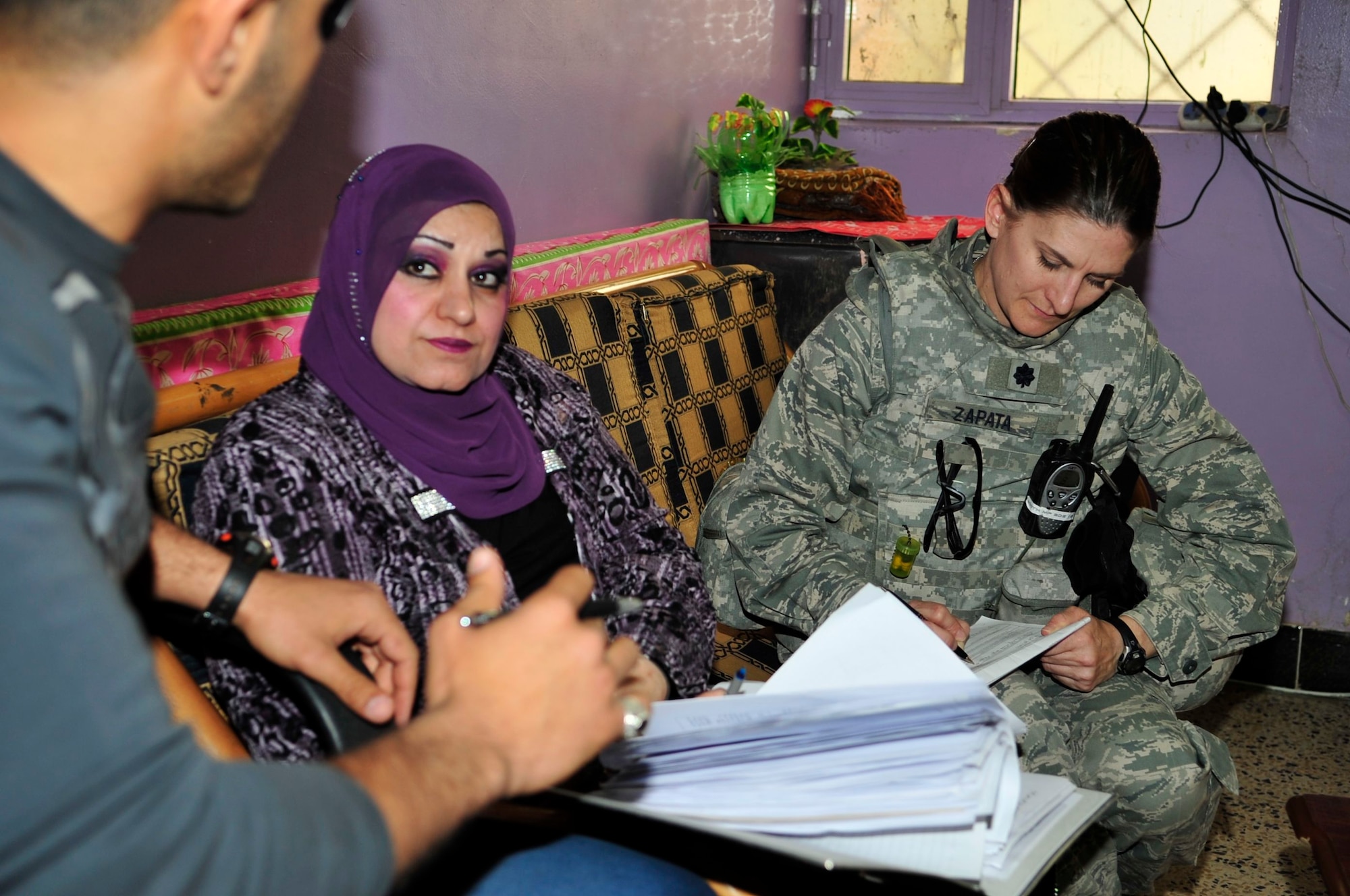 U.S. Air Force Lt. Col. Kaylin Haywood Zapata, Edmond, Okla., native and an Iraq Training and Advisory Mission – Police oil and electric police advisor, takes notes as she interviews the female warden at a women’s prison in Baghdad’s Rusafa District, Iraq, April 6, 2011. Colonel Haywood Zapata is asking her questions and identifying conditions at the facility as part of a U.S. Forces – Iraq provost marshal office corrections assistance transition team assessment. (U.S. Air Force photo by Senior Master Sgt. Larry A. Schneck/Released)