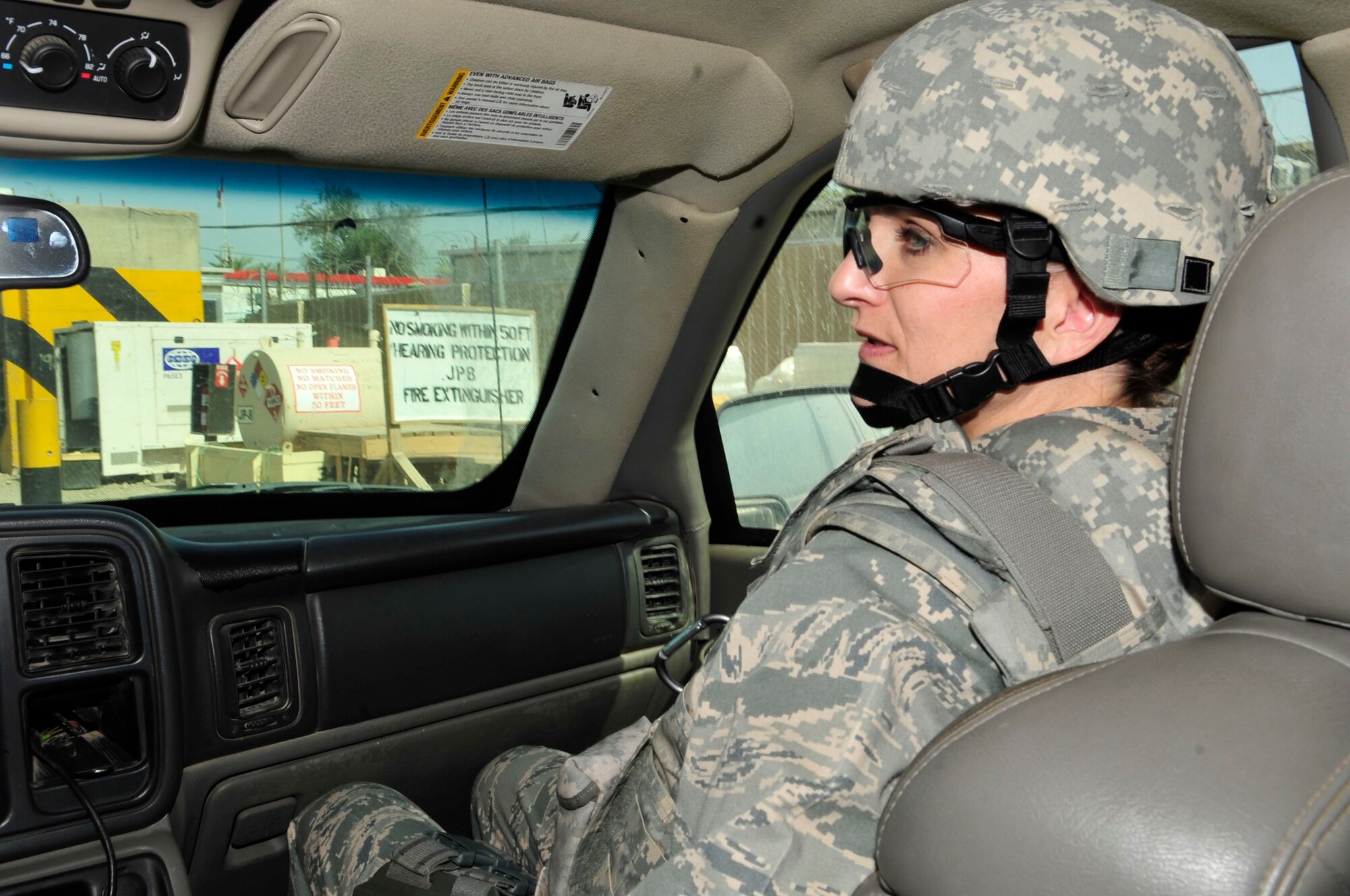 U.S. Air Force Lt. Col. Kaylin Haywood Zapata, Edmond, Okla., native and an Iraq Training and Advisory Mission – Police oil and electric police advisor, rides in an armored SUV while in a convoy to the Rusafa Prison Complex, Baghdad, Iraq, April 6, 2011. She is helping assess the conditions at a women’s prison as a member of the corrections assistance transition team. (U.S. Air Force photo by Senior Master Sgt. Larry A. Schneck/Released)