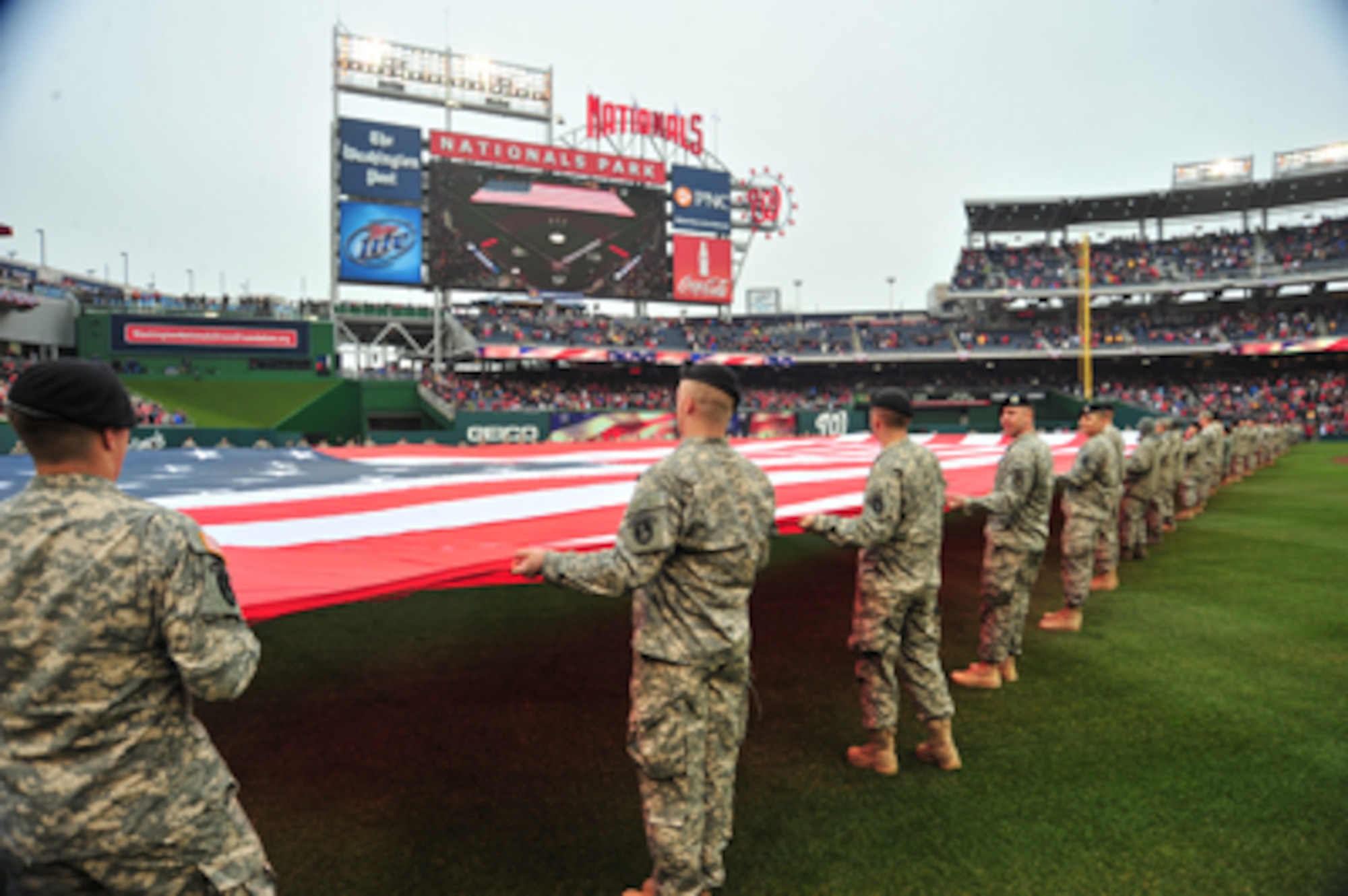 Members of the D.C. National Guard hold a football-field sized American flag on the outfield during pre-game ceremonies for Opening Day at Nationals Park in Washington, D.C. March 31, 2011. U.S. Air Force Photo by Tech. Sgt. Tyrell Heaton 