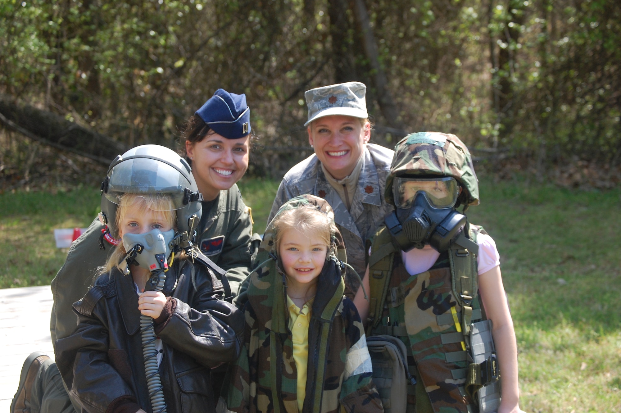 Capt. Jessica Guarini and Maj. Shannon Mann pose with future Airmen of the 916th Air Refueling Wing. The two officers represented the Air Refueling Wing during a community day at a local school on April 8. (USAF photo)