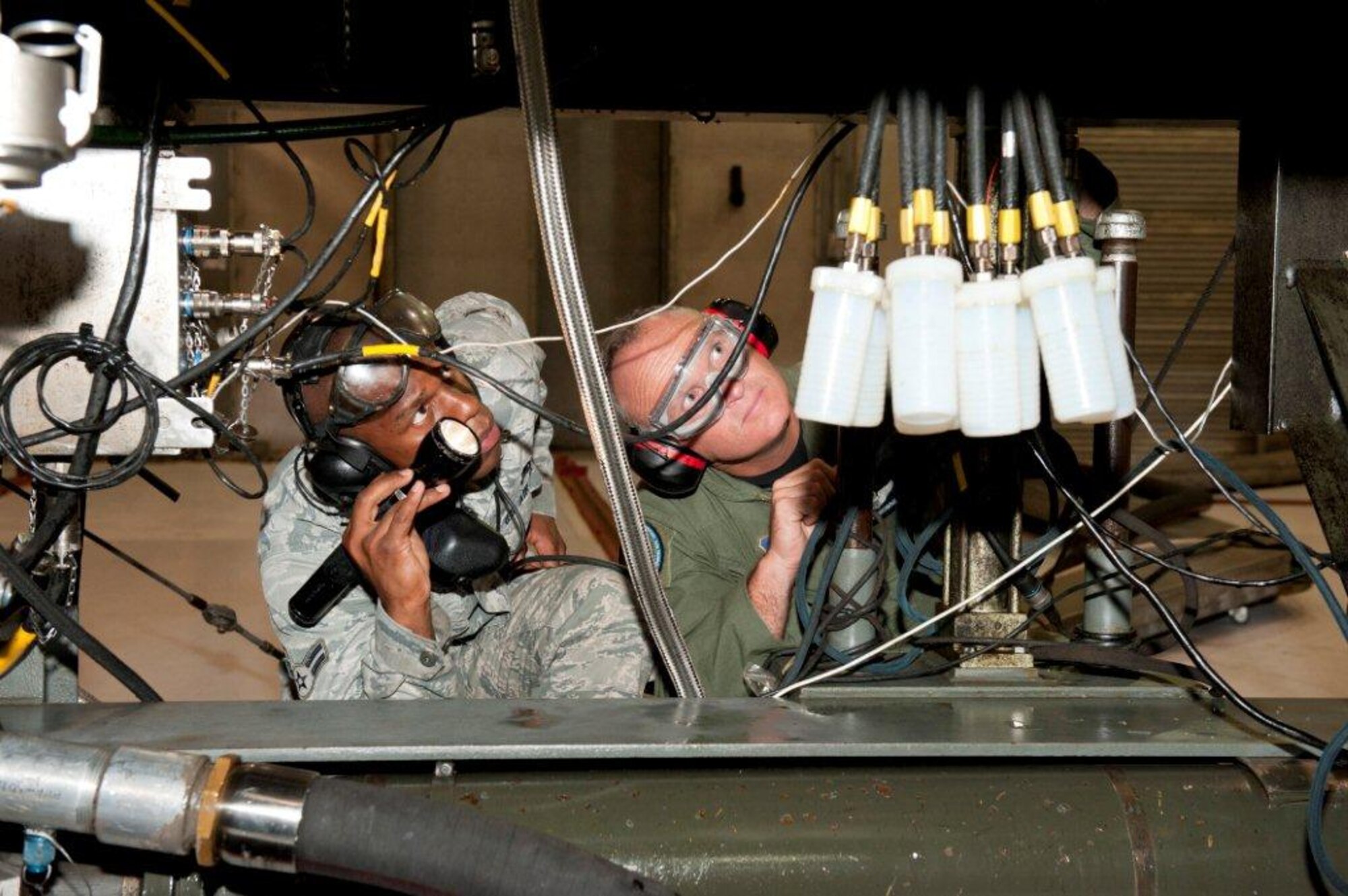 Airman 1st Class Jerylmayne White, 325th Maintenance Squadron propulsion journeyman and engine test cell member, took Brigadier General James Browne, 325th Fighter Wing commander, through his daily procedures at the test cell building and hush house April 4, as part of the Commander's Shadow program. (U.S. Air Force photo by Jonathan Gibson)
