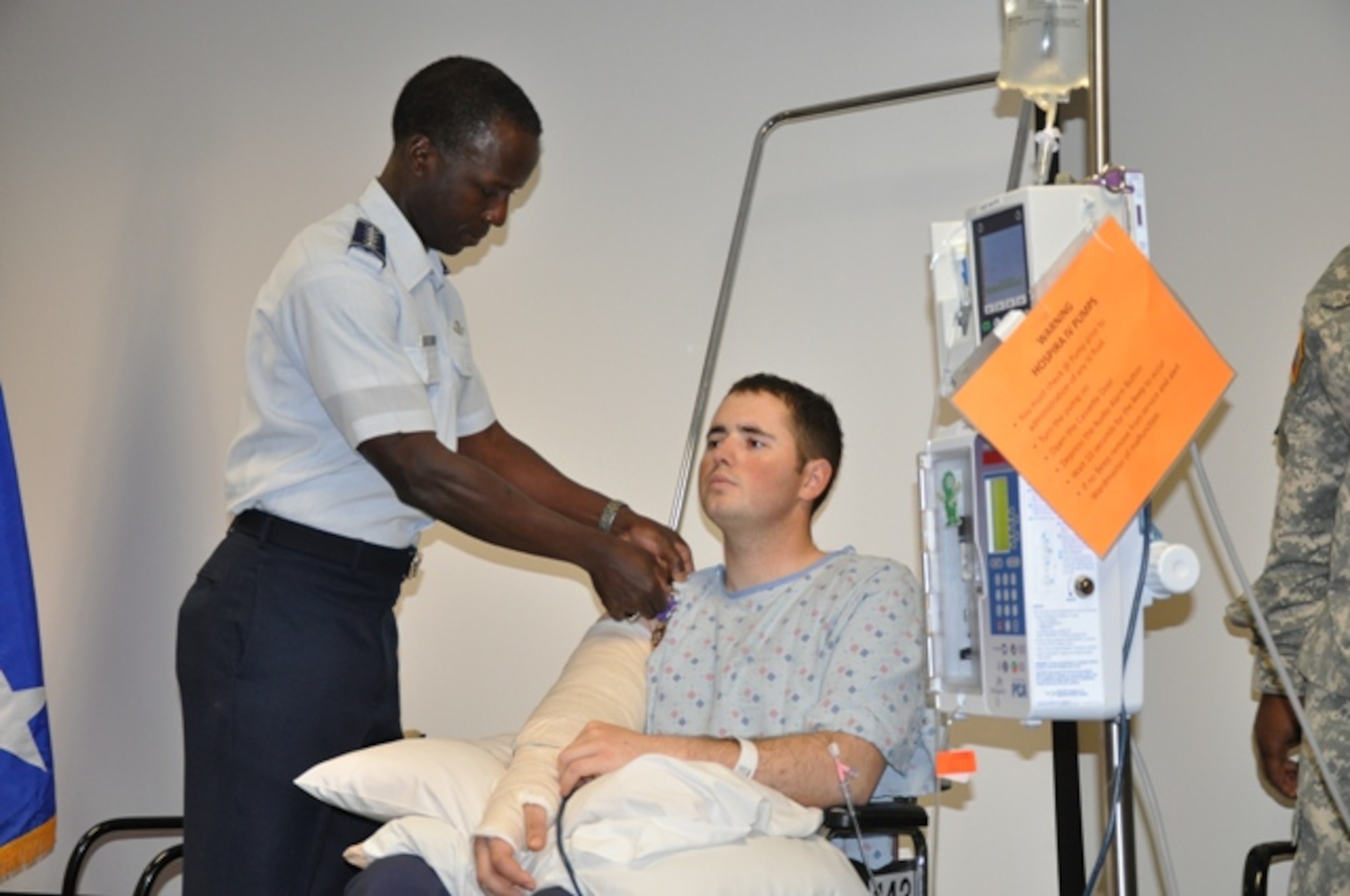 FORT SAM HOUSTON, Texas -- General Edward A. Rice Jr., commander, Air Education and Training Command, presents the Purple Heart and Air Force Combat Action Medals April 6 to Senior Airman Erik J. Schadler. Airman Schadler, an explosive ordnance disposal specialist assigned to the 21st Civil Engineering Squadron at Peterson AFB, Colo., was awarded the medals for wounds received in combat action against a hostile enemy force in Afghanistan. Airman Schadler is a native of Las Cruces, N.M. (Photo by Russell Fritz)


