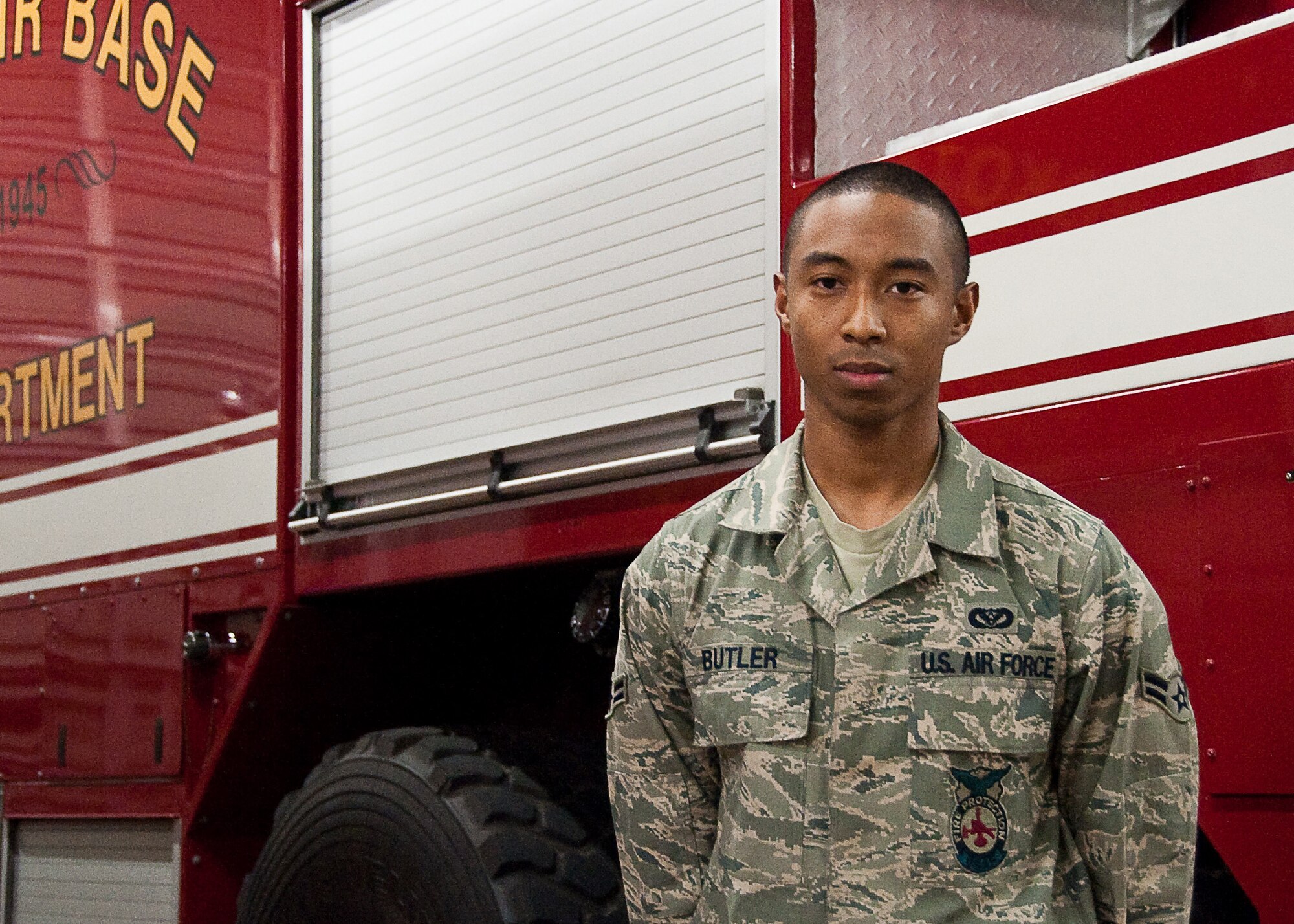 YOKOTA AIR BASE, Japan -- Airman 1st Class Leonard Butler, 374th Civil Engineer Squadron firefighter, stands in front of a fire truck here April 7, 2011. The Panama City, Fla., native is stationed in Japan and is currently supporting Operation Tomodachi. (U.S. Air Force photo/Airman 1st Class Andrea Salazar)