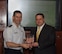 Martin Hansen, the Infrastructure Acquisition flight chief, receives the Secretary of the Air Force Professionalism in Contracting (non-supervisory) award from Brig. Gen. Ken Wilsbach, the 18th Wing commander, here at Kadena Air Basae, March 21. This was one of five individual awards the contracting squadron received. The 18th CONS was also named Outstanding Large Contracting Unit in the Pacific Air Force. (U.S. Air Force photo/Senior Airman George Halley)