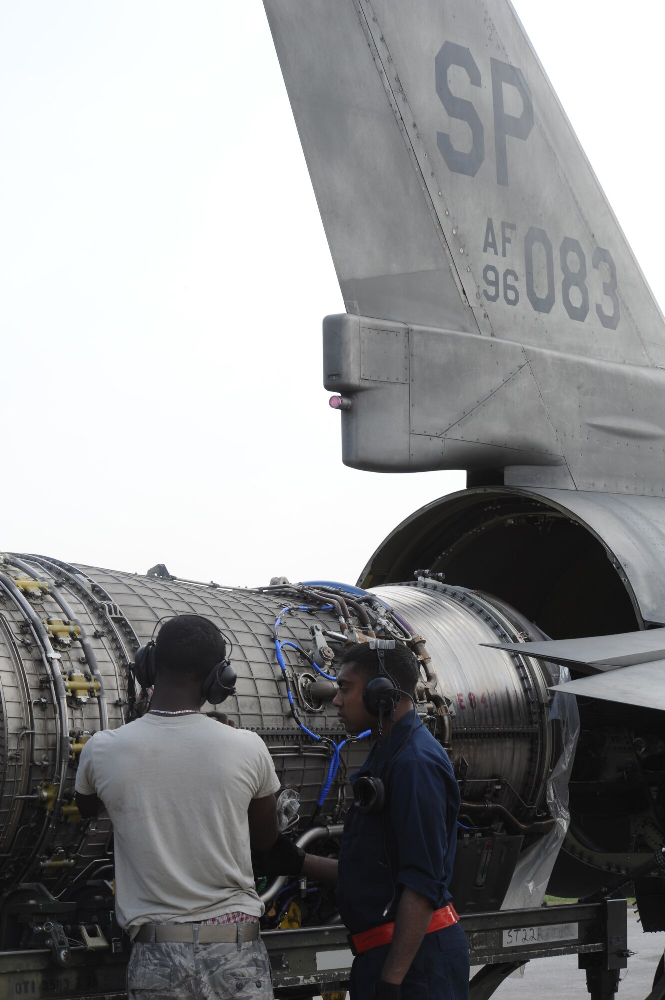 Staff Sgt. Kemp Roderick and Airman 1st Class Amarawardana Danitha, 52nd Aircraft Maintenance Squadron, perform maintenance on an F-16 Fighting Falcon engine during Operation Odyssey Dawn, now Operation Unified Protector for the enforcement of UNSCRs 1970 and 1973, March 31, 2011 at Aviano Air Base, Italy. (U.S. Air Force photo/ Staff Sgt. Nadine Y. Barclay)