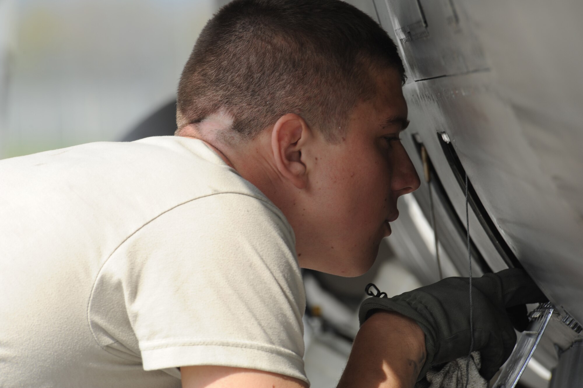Airman Andrey Vasilchuk, 52nd Aircraft Maintenance Squadron, inspects an F-16 Fighting Falcon compartment at Aviano Air Base, Italy, for any possible flight damage March 31, 2011. Airman Vasilchuk deployed to Aviano AB from Spangdahlem Air Base, Germany in support of Operation Odyssey Dawn, now Operation Unified Protector, for the enforcement of UNSCRs 1970 and 1973. (U.S. Air Force photo/ Staff Sgt. Nadine Y. Barclay)