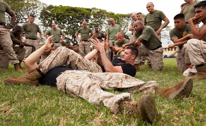 Sgt. John Badon, a third-degree black belt Marine Corps Martial Arts Program instructor-trainer with the Marine Corps Martial Arts Center of Excellence, demonstrates a MCMAP technique on fellow instructor-trainer Sgt. Steven Richardson to students of a second degree advancement and re-certification workshop held by the MACE’s mobile training team on Marine Corps Base Hawaii, April 11, 2011. The team of top-level MACE instructors, coming to Hawaii from the Marine Corps’ MCMAP hub in Quantico, Va., offered more than 40 Hawaii-based Marines the opportunity to renew their three-year certifications as MCMAP instructors and instructor-trainers, and advance their belts to the second degree during the week-long workshop.