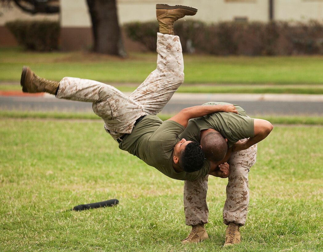Sgt. Robert Hernandez, a black belt Marine Corps Martial Arts Program instructor with the School of Infantry West — Detachment Hawaii, performs a hip throw on fellow instructor Sgt. Joaquin Recuero, a flight line equipment mechanic with Marine Heavy Helicopter Squadron 363, during a MCMAP second degree advancement and re-certification workshop held by a mobile training team from the Marine Corps Martial Arts Center of Excellence on Marine Corps Base Hawaii, April 11, 2011. The team of top-level MACE instructors, coming to Hawaii from the Marine Corps’ MCMAP hub in Quantico, Va., offered more than 40 Hawaii-based Marines the opportunity to renew their three-year certifications as MCMAP instructors and instructor-trainers, and advance their belts to the second degree during the week-long workshop.