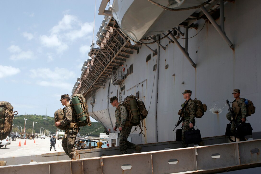Members of the 31st Marine Expeditionary Unit, carry their gear off USS Essex (LHD 2), after arriving in Okinawa, April 12. The 31st MEU participated in exercises in the Kingdom of Thailand, Kingdom of Cambodia, and conducted humanitarian aid and disaster relief operations in mainland Japan in support of Operation Tomodachi, during a deployment of the Asia-Pacific Theater.