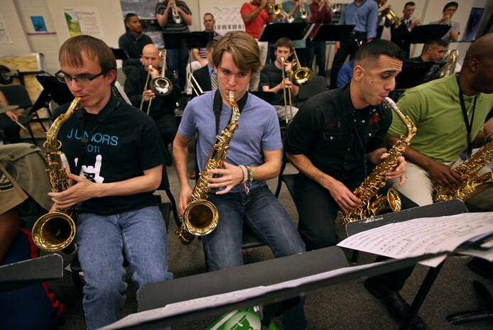 Staff Sgt. Mark Pellon, an alto saxophonist in the Marine Corps All Star Jazz Band, plays with two band students on his right at Traverse City West High School, Traverse City, Mich., April 12, 2011. Marine musicians from the 12 field bands auditioned to be a part of the all star jazz band and 18 were chosen to be a part of the recruiting tour across Michigan.