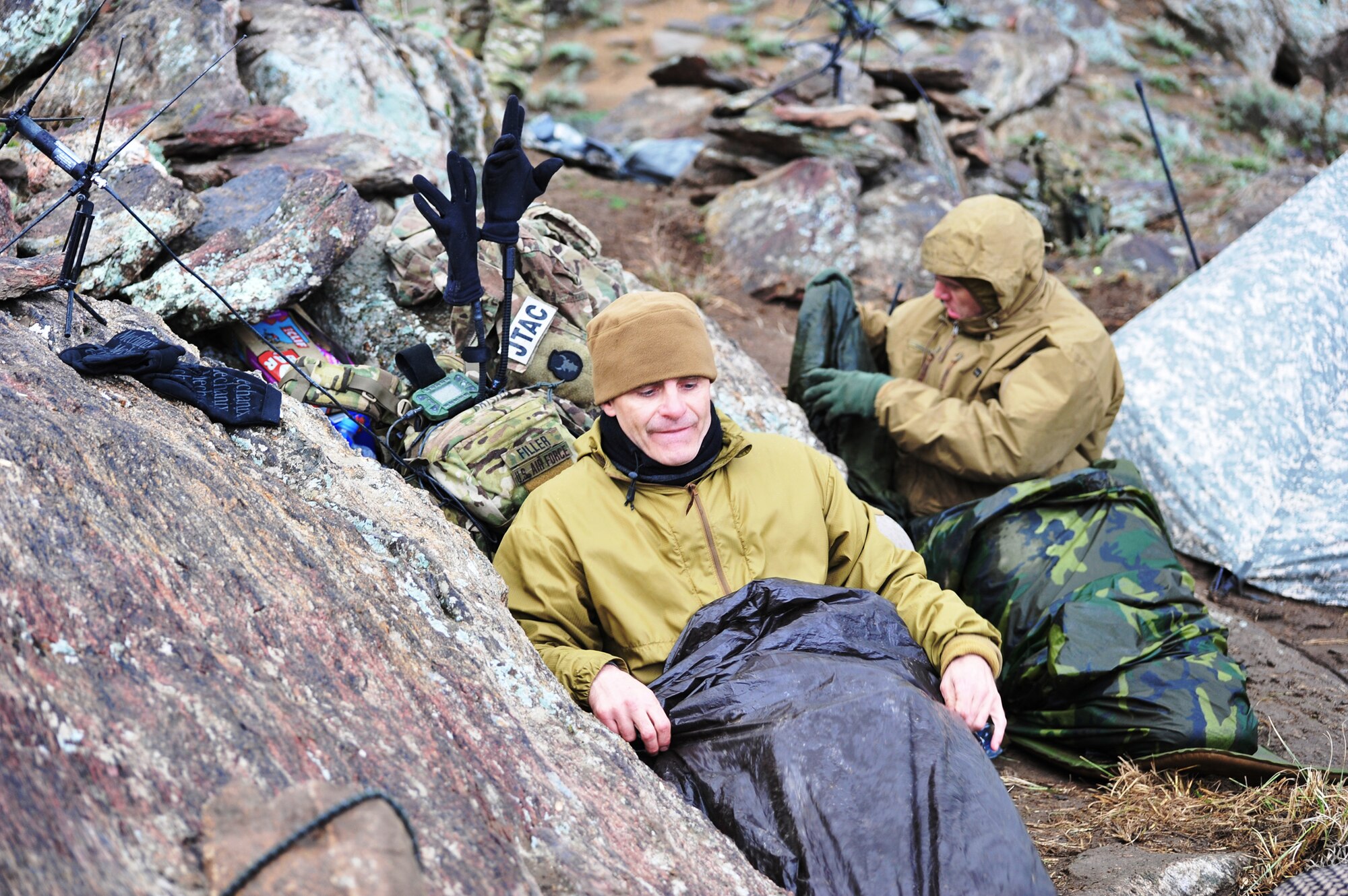 Lt. Col. Brian Filler (left) and Tech. Sgt. Jonathan Oliver prepare to sleep in austere conditions upon a remote mountaintop March 28, 2011, during Operation Bull Whip in Laghman province, Afghanistan. Colonel Filler is an air liaison officer. Sergeant Oliver is a joint terminal attack controller. Both Airmen are assigned to Bagram Airfield's 817th Expeditionary Air Support Operations Squadron, and were responsible for controlling air assets during the clearing operation. (U.S. Air Force photo/Capt. Erick Saks) 