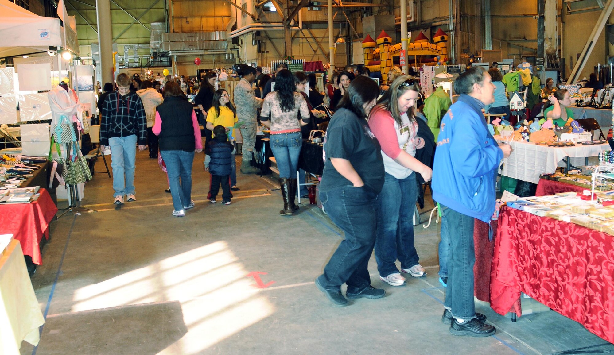 Visitors shop at the Eielson Open House and Bazaar April 9 and 10, 2011, Eielson Air Force Base, Alaska. This event was an opportunity to invite people from the local area to see a little piece of Eielson and build and foster relations between military and civilian communities. (U.S. Air Force photo/ Airman 1st Class Janine Thibault)