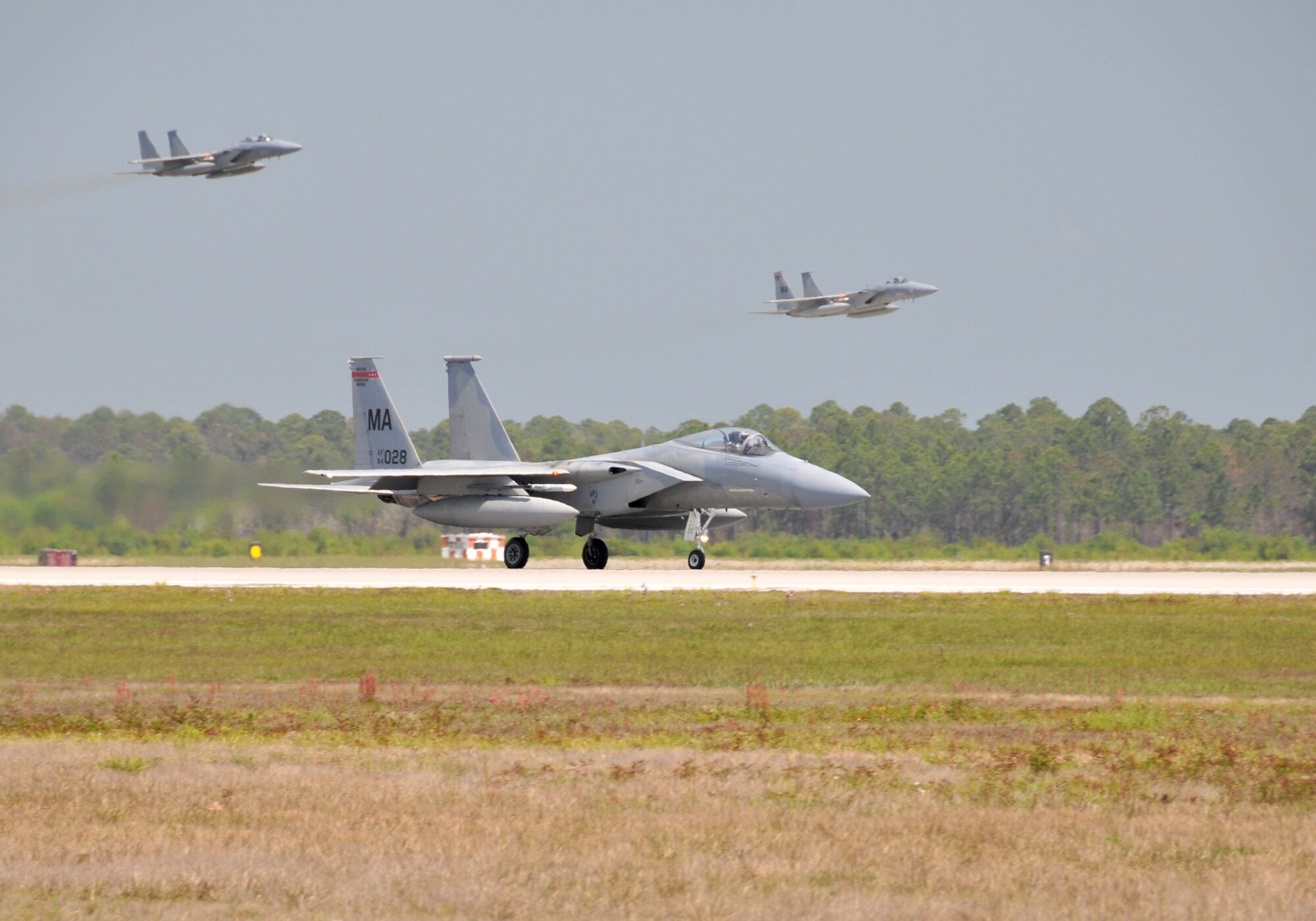 F-15 Eagles from the Massachusetts Air National Guard‘s 104th Fighter Wing arrive at Tyndall Air Force Base, Fla., April 9, 2011, to participate in the Weapons System Evaluation Program there. The two-week training and evaluation program is important for ground crews to test their maintenance systems and processes while loading live munitions on the fighters. The WSEP also provides live training for the F-15 pilots to employ air-to-air missiles against remotely piloted target drones in flight.  (U.S. Air Force photo/Master Sgt. Mark W. Fortin)