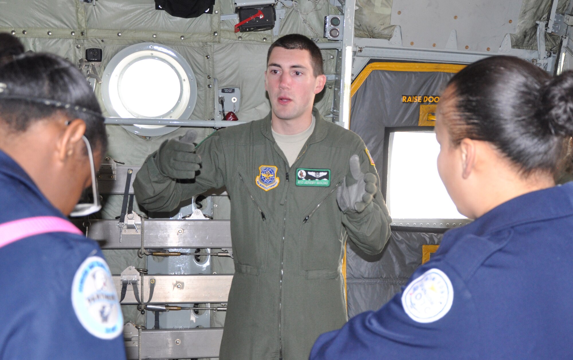 Airman 1st Class Jeremy Wolski, a 52nd Airlift Squadron C-130H loadmaster, answers questions from Air Force Junior Reserve Officers' Training Corps cadets April 12 at Peterson Air Force Base, Colo. The 22 students from Colorado Springs' Harrison High School stopped by the 302nd Airlift Wing during their base visit, where they toured a C-130H aircraft and learned about career options in the Air Force Reserve. (U.S. Air Force photo/Tech. Sgt. Daniel Butterfield) 