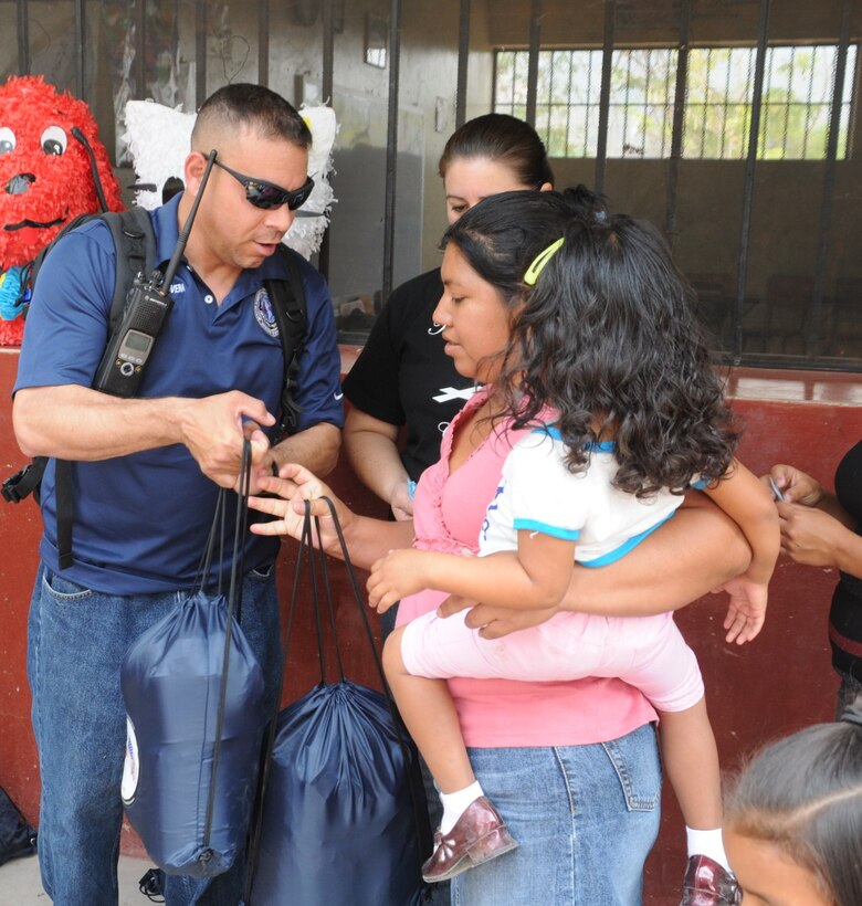 Joint Task Force-Bravo’s Army Forces 1st Sgt. Ernesto RiveraRodriguez hands out donations during the Chapel Hike to El Taladro, April 9. Chapel Hikes allow members from Soto Cano Air Base to interact with their Honduran neighbors while providing them with necessary sustainment foods (U.S. Air Force photo/Staff Sgt. Kimberly Rae Moore.)