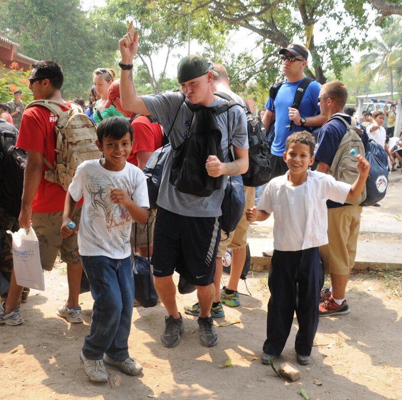 Staff Sgt. Ronald Myers, Joint Task Force-Bravo Personnel deputy director, plays dances with children in El Taladro April 9. The base conducted a chapel hike donating 130 bags of sustainment foods to their neighbors in need. (U.S. Air Force photo/Staff Sgt. Kimberly Rae Moore.)