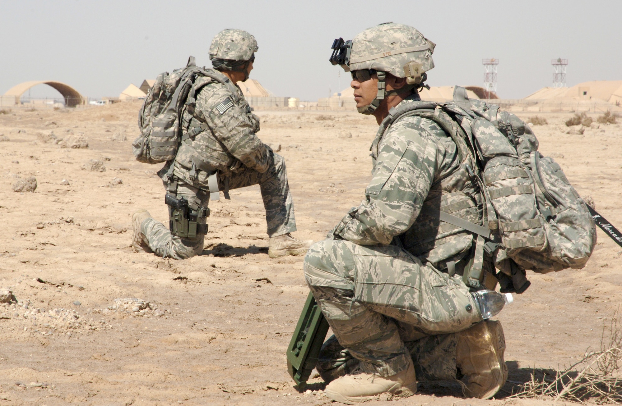 Senior Airman Jesse Mercado (front) and Staff Sgt. Christin Merriweather look for hidden dangers during a training scenario March 3, 2011, at Ali Air Base, Iraq. Airman Mercado and Sergeant Merriweather are explosive ordnance disposal technicians assigned to the 407th Expeditionary Operations Support Squadron. (U.S. Air Force photo/Staff Sgt. R. Michael Longoria)