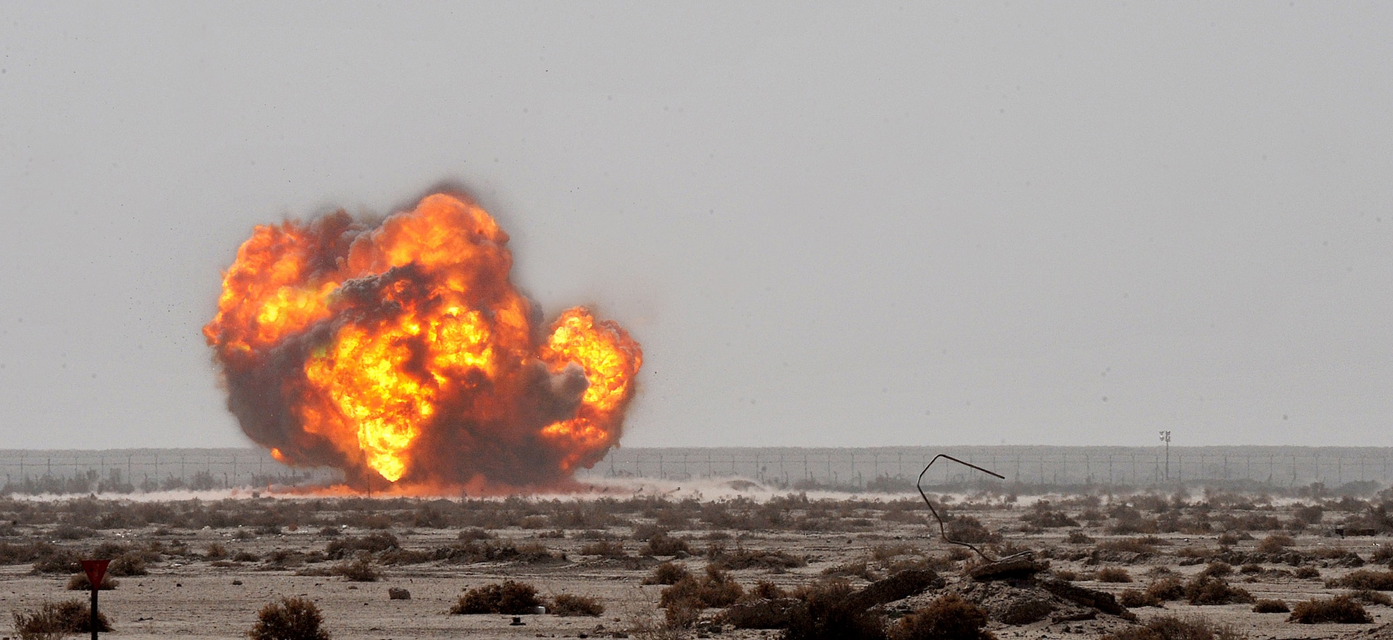Members of the 407th Expeditionary Operations Support Squadron explosive ordnance disposal team along with members of Army EOD team successfully detonate a pile of 40-millimeter rounds and C-4 March 3, 2011, at Ali Air Base, Iraq. (U.S. Air Force photo/Senior Airman Andrew Lee) 