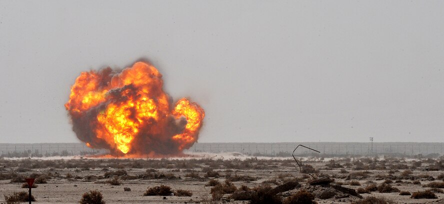 Members of the 407th Expeditionary Operations Support Squadron explosive ordnance disposal team along with members of Army EOD team successfully detonate a pile of 40-millimeter rounds and C-4 March 3, 2011, at Ali Air Base, Iraq. (U.S. Air Force photo/Senior Airman Andrew Lee) 