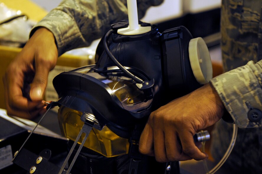 Airman Patrick Martin, 2nd Logistics Readiness Squadron individual protective equipment apprentice, performs a leak test on an M50 gas mask at Barksdale Air Force Base, La., April 12. Airman Martin is preparing for a gas mask mass-issuance in June. The IPE section issues and inspects deployment and training gear including gas masks, inner ballistic armor, chemical warfare gear and weapons. (U.S. Air Force photo/Staff Sgt. John Gordinier)