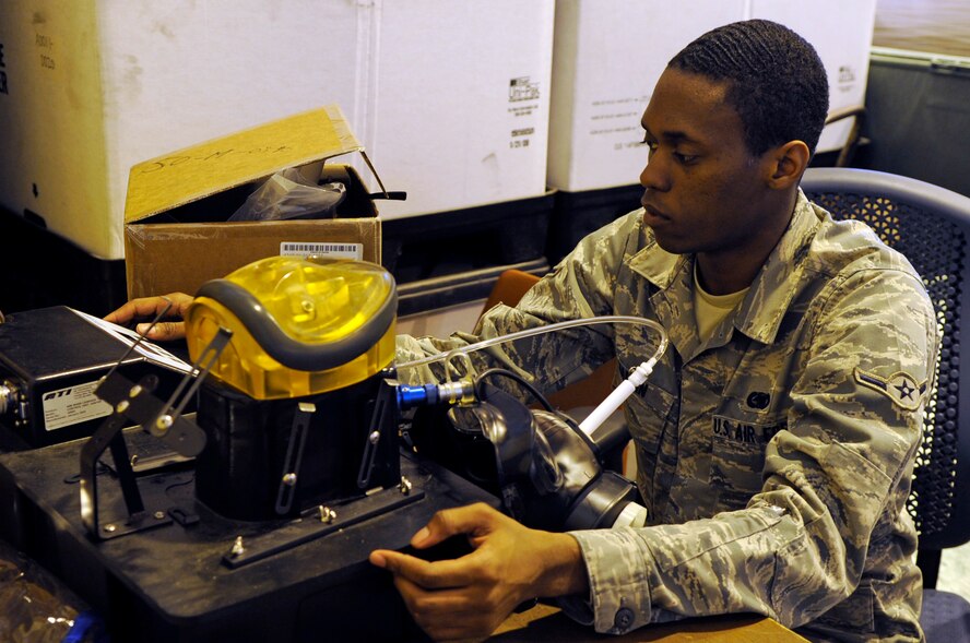 Airman Patrick Martin, 2nd Logistics Readiness Squadron individual protective equipment apprentice, performs a leak test on an M50 gas mask at Barksdale Air Force Base, La., April 12. Airman Martin is preparing for a gas mask mass-issuance in June. The IPE section issues and inspects deployment and training gear including gas masks, inner ballistic armor, chemical warfare gear and weapons. (U.S. Air Force photo/Staff Sgt. John Gordinier)
