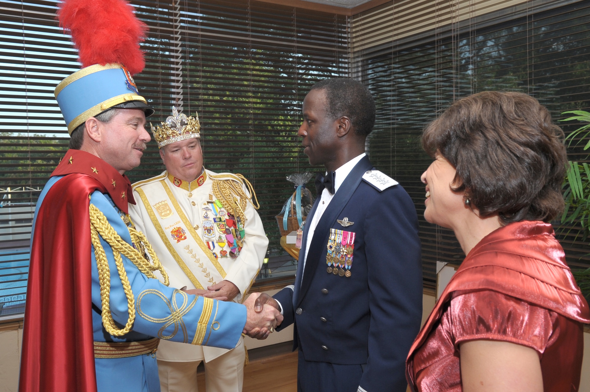 King Antonio Bill Mitchell shakes hands with Gen. Edward A. Rice, Jr., Air Education and Training Command commander, in the company of El Rey Feo Bill Drain, and Teresa Rice, Gen. Rice's wife, at the Opening Ceremony for Fiesta April 6. Fiesta is an annual two-week celebration held in San Antonio. (U.S. Air Force photo/Airman Alexis Siekert)