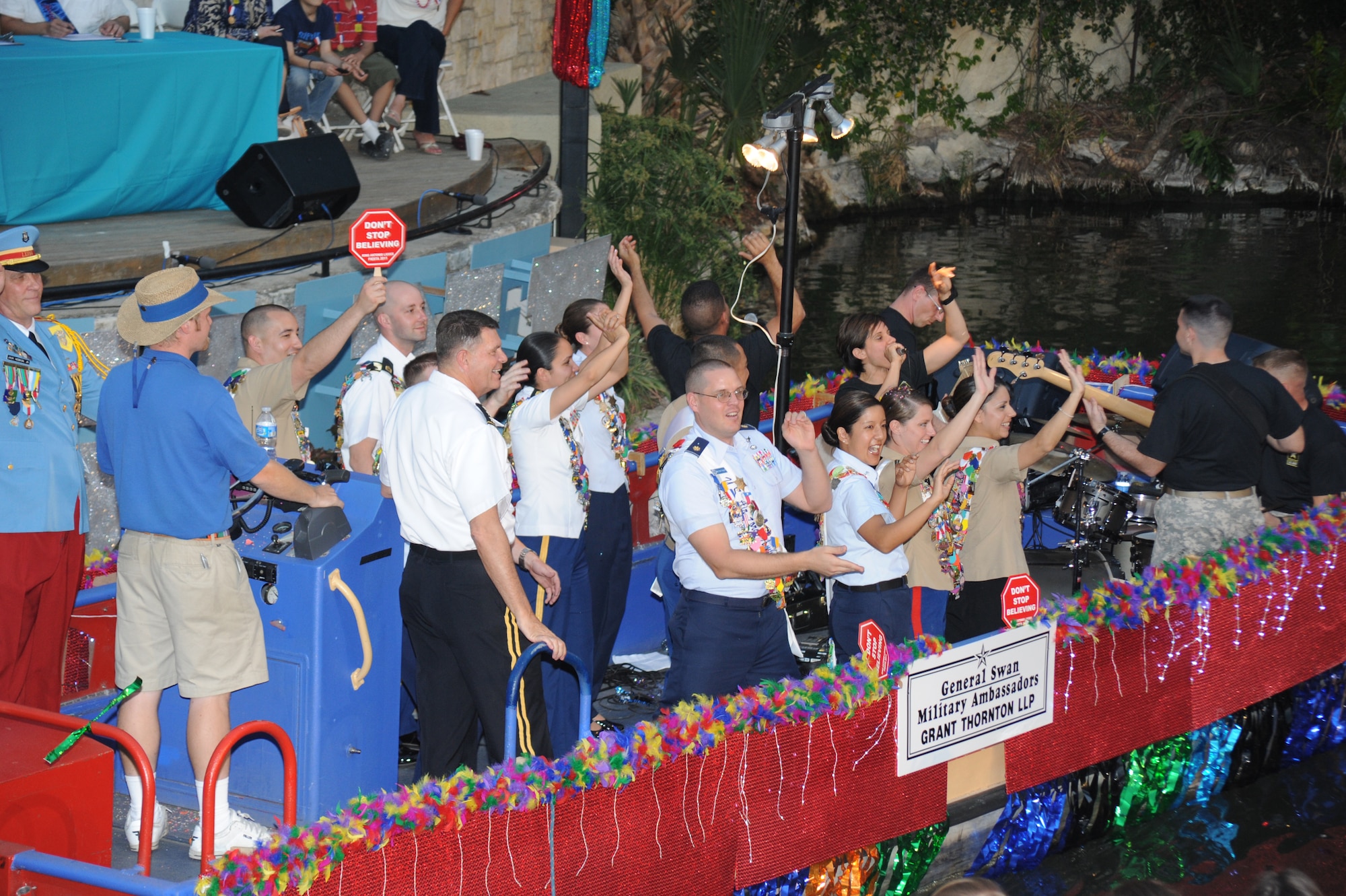Military ambassadors wave to the crowd as they pass on their float during the Fiesta River Parade on the San Antonio River Walk April 11. Fiesta is an annual two-week celebration held in San Antonio. (U.S. Air Force photo/David Terry)
