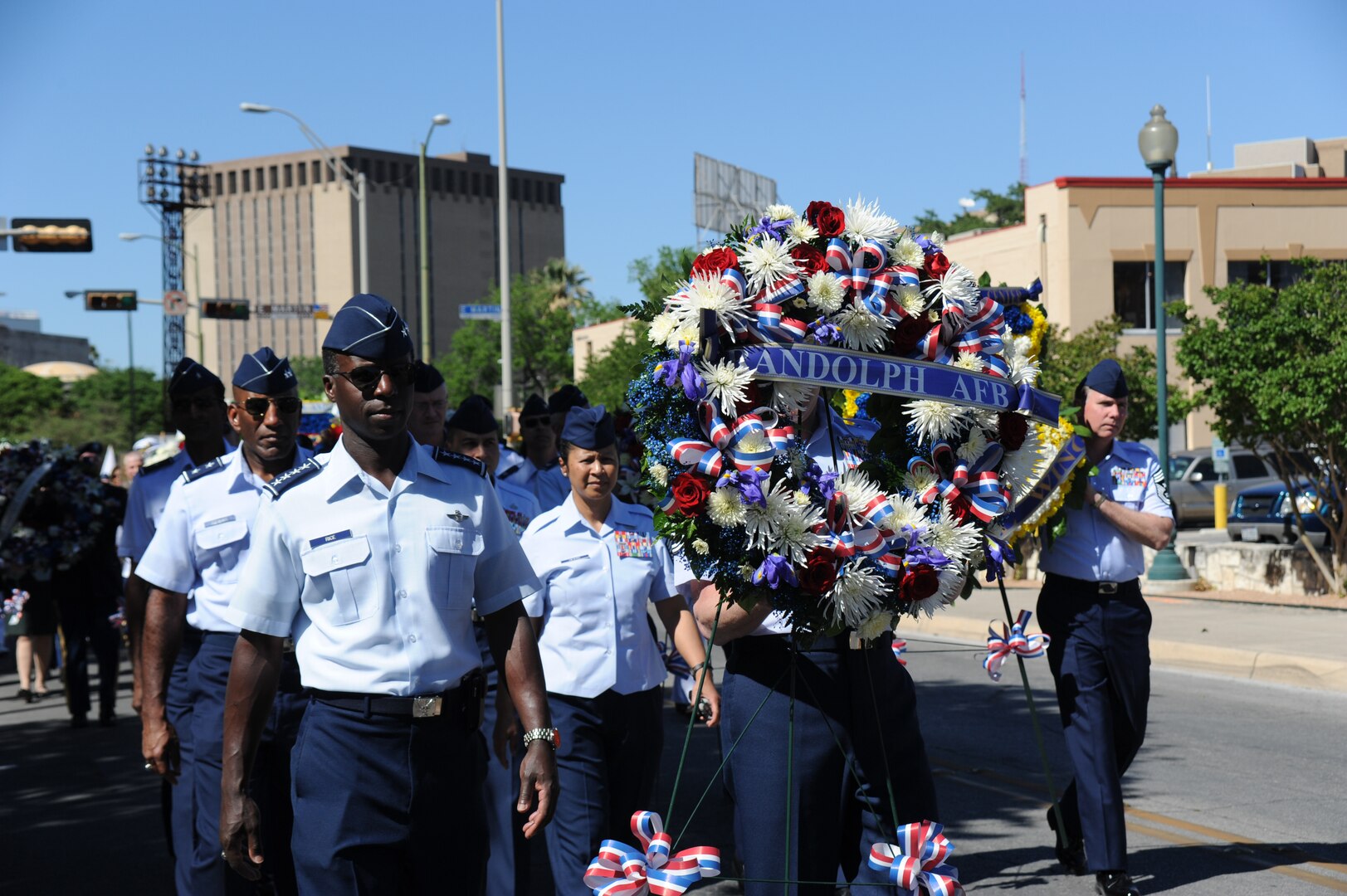 Gen. Edward A. Rice, Jr., Air Education and Training Command commander, followed by Maj. Gen. A.J. Stewart, Air Force Personnel Center commander, along with other Air Force representatives, walk the Randolph wreath to the Alamo as part of the Pilgrimage April 11 during Fiesta 2011. Fiesta is an annual two-week celebration in San Antonio. (U.S. Air Force photo/David Terry)