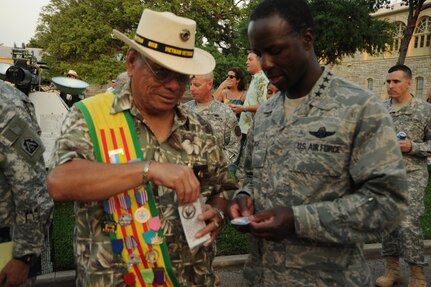 Daniel Medrano, Vietnam Veterans of America Chapter 366 president, exchanges medals with Gen. Edward A. Rice, Jr., Air Education and Training Command commander, at Fort Sam Houston April 9 during a Fiesta event. Fiesta is an annual two-week celebration held in San Antonio. (U.S. Air Force photo/Airman Alexis Siekert)