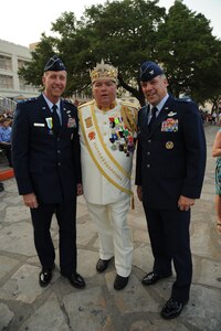 (Left to right) Maj. Gen. Mark Solo, 19th Air Force commander, Bill Drain, 2011 El Rey Feo, and Col. Richard Murphy, 12th Flying Training Wing commander, pose for a photo during Investiture at the Alamo Plaza April 9 as part of the Fiesta celebration. Fiesta is an annual two-week celebration held in San Antonio. (U.S. Air Force photo/Airman Alexis Siekert)