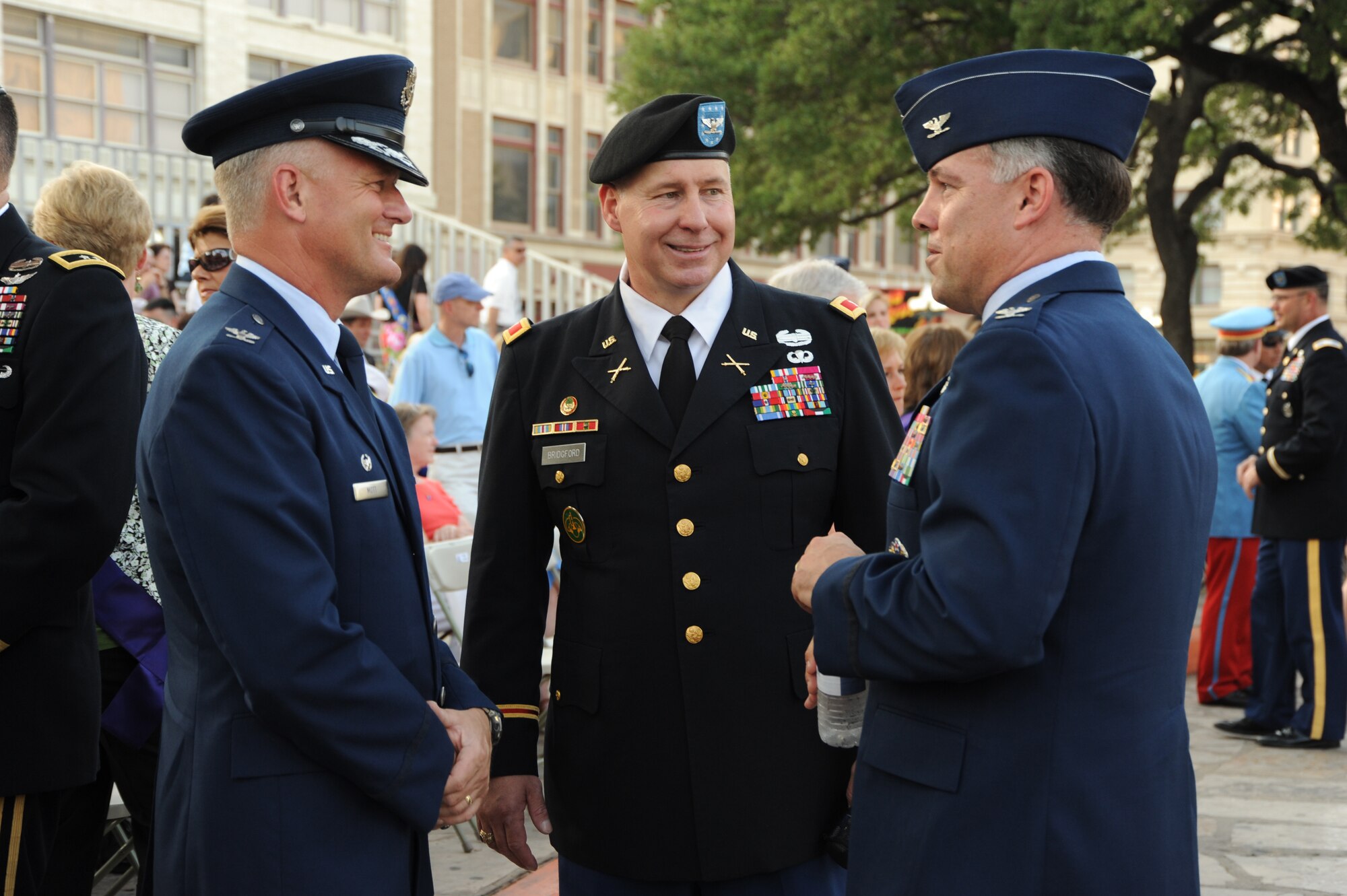 (Left to right) Col. William Mott, 37th Training Wing commander, Col. Robert Bridgford, 502nd Air Base Wing vice commander, and Col. Richard Murphy, 12th Flying Training Wing commander, socialize before the Investiture ceremony at the Alamo Plaza April 9 as part of the Fiesta celebration. Fiesta is an annual two-week celebration held in San Antonio. (U.S. Air Force photo/Airman Alexis Siekert)