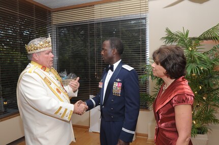 Bill Drain, 2011 El Rey Feo, is greeted by Gen. Edward A. Rice, Jr., Air Education and Training Command commander, and his wife, Teresa, at the AETC Fiesta ceremony at the Parr O'Club April 6 at Randolph Air Force Base, Texas. Fiesta is an annual two-week celebration held in San Antonio. (U.S. Air Force photo/Airman Alexis Siekert)