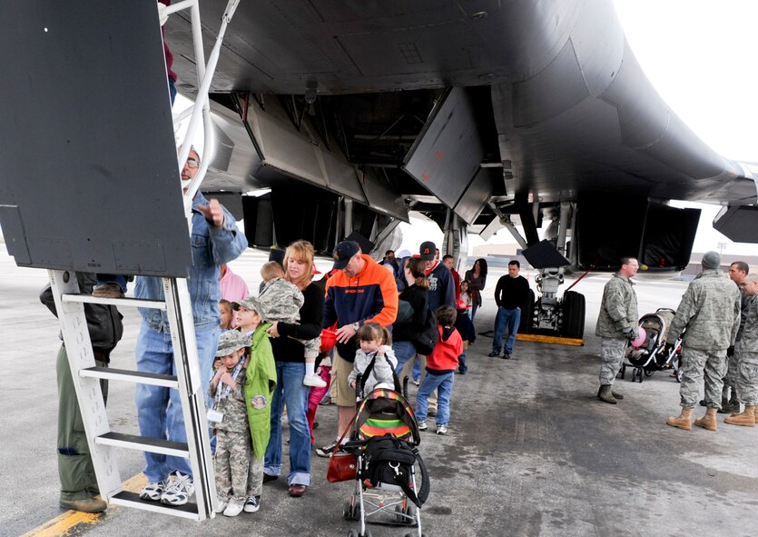 Spouses and children line up to tour a B-1B Lancer during “KUDOS, SUDOS and TUDOS,” an event which helps kids, spouses and teachers better understand the deployment process, April 09, 2011, at Ellsworth Air Force Base. The event included demonstrations from explosive ordnance disposal, the fire department, readiness flight, military working dogs and other base organizations.   (U.S. Air Force photo/Senior Airman Adam Grant)  
