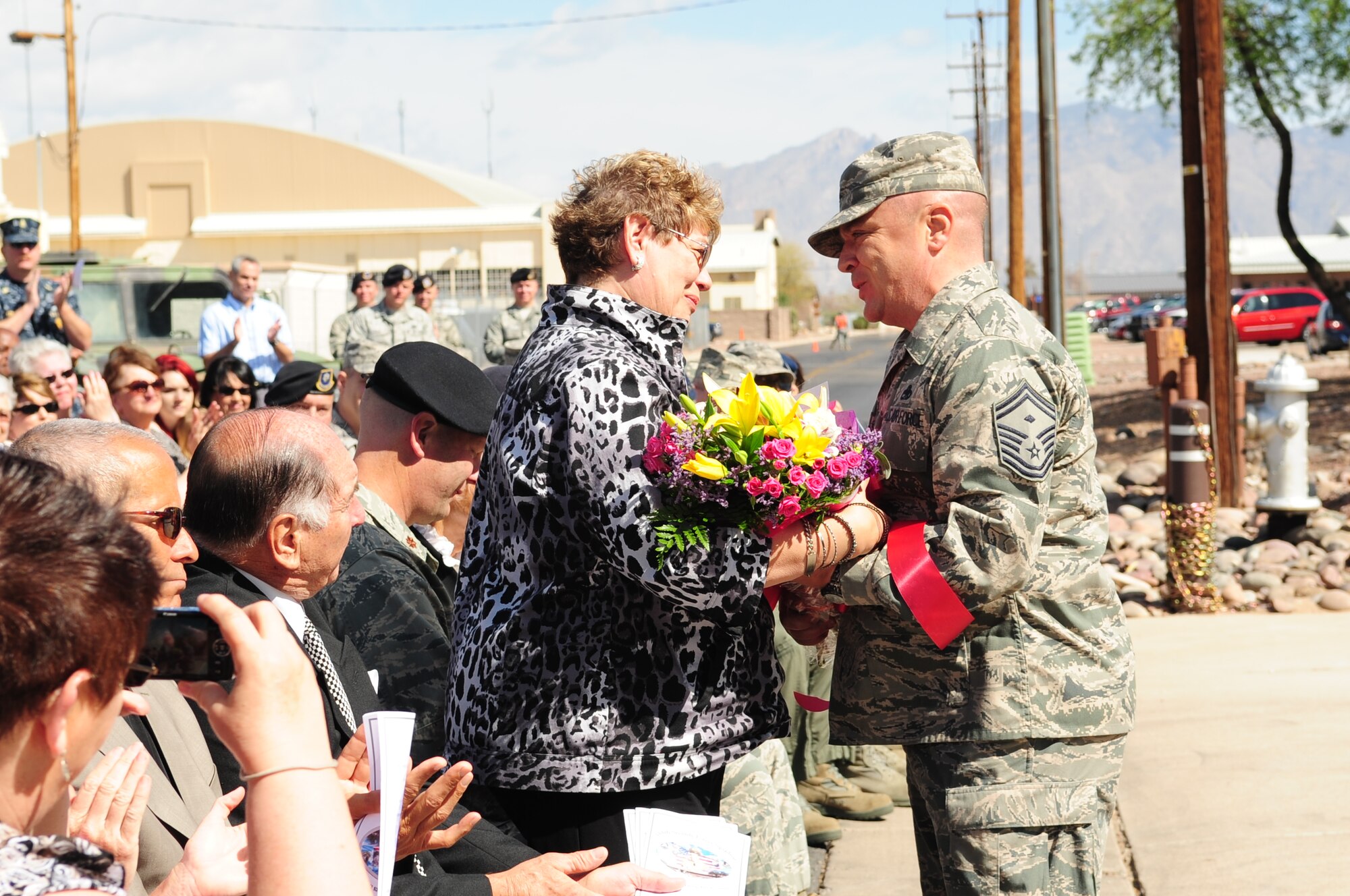 DAVIS-MONTHAN AIR FORCE BASE, Ariz. – Senior Master Sgt. John Skaggs, Security Forces First Sergeant, presents Airman Lehman’s former fiancé, Erlyce Pekas, a bouquet of flowers here April 8. The 355th building renaming ceremony was to honor Airman 1st Class Millard Lehman, who was killed in action in the Vietnam War. (U.S. Air Force photo/Airman 1st Class Jerilyn Quintanilla)
