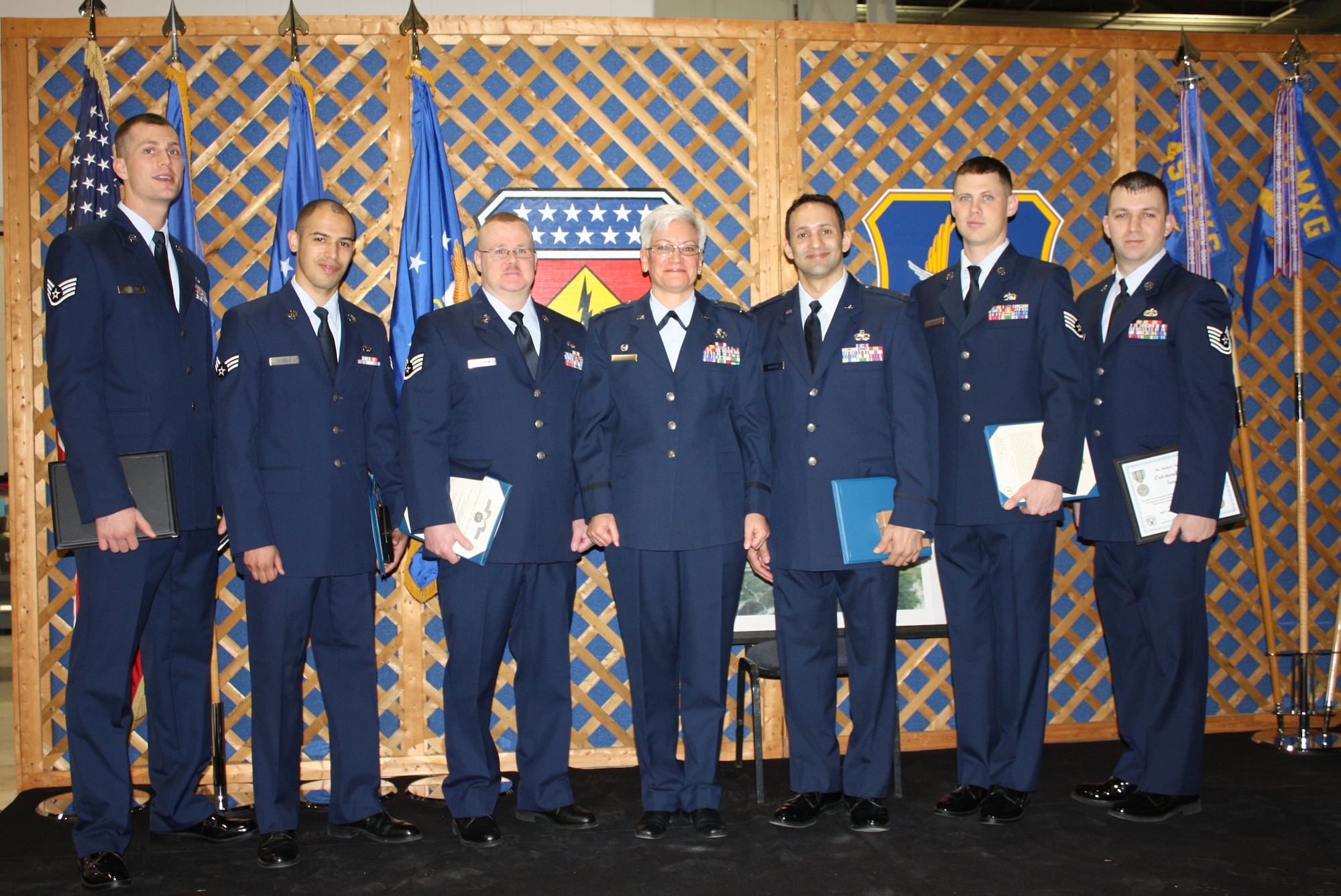 WRIGHT-PATTERSON AIR FORCE BASE, Ohio – Six reservists from the 445th Maintenance Squadron are the recipients of medals presented by Col. Anna Schulte, 445th Maintenance Group commander, during the group’s March unit training assembly group call. From left to right; Staff Sgt. Sean Fowler, Senior Airman Christopher Echols, Staff Sgt. Scott Spielman, Colonel Schulte, Capt. Anthony Colberg, Staff Sgt. Daniel Baker, and Tech. Sgt. Bradley Rossignol. (U.S. Air Force photo/Maj. Paula Fiepke)   