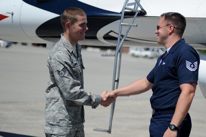 Senior Airman Nick Braun, a 437th Aerial Port Squadron air transportation journeyman, shakes the hand of his older brother, Tech. Sgt. Ted Braun from the U.S. Air Force Thunderbirds, April 7. The U.S. Air Force Thunderbirds were here to perform during the Charleston Air Expo 2011. (U.S. Air Force photo/Staff Sgt. Nicole Mickle)