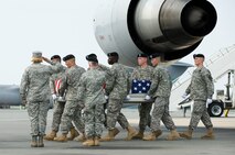 Air Force Col. Sharon Bannister, dignified transfer host, and Army Major General Merdith W. B. Temple, general officer, salute as a U.S. Army carry team transfers the remains of Army Spc. Jamal M. Rhett at Dover Air Force Base, Del., Aug. 17, 2010. Colonel Bannister is one of nine colonels at Dover AFB who share the duty of calling the orders at dignified transfers honoring fallen servicemembers who return to U.S. soil. (U.S. Air Force photo/Jason Minto)
