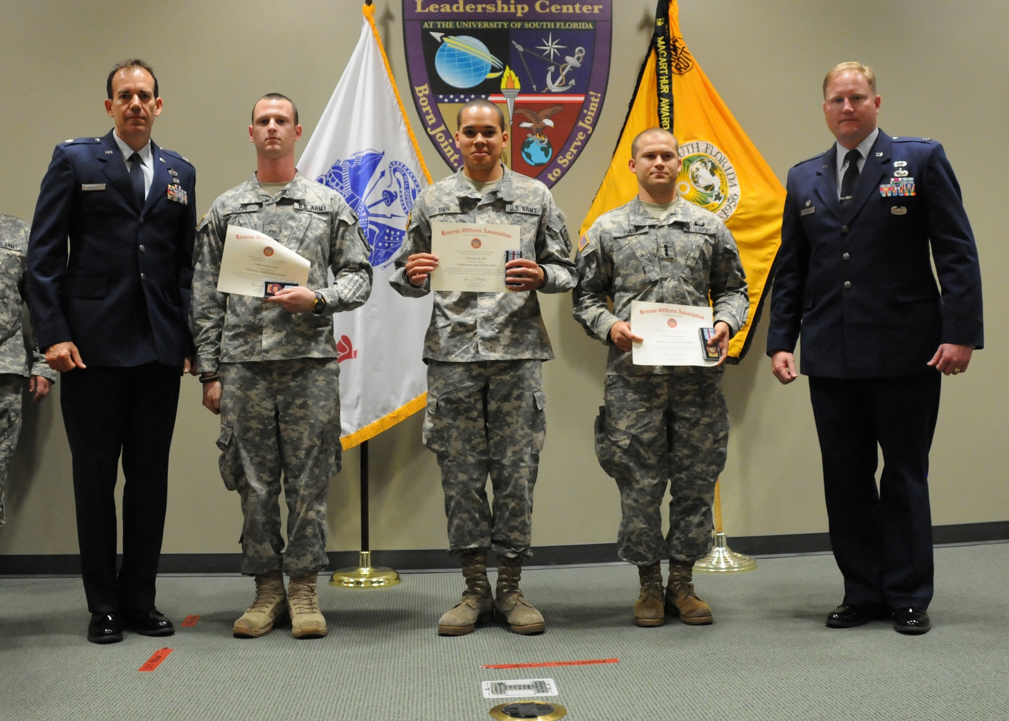 Tampa, Fla. -- Lieutenant Col. Bruce Winhold and Capt. Brett Wedding, both of the 927th Air Refueling Wing, recognized 3 Army ROTC cadets at the University of South Florida April 4. From left to right, Army Cadets Corbin Colini, Louis Then, and Alexander Ham received the awards. The officers travelled to the university on behalf of the Reserve Officer's Association, a professional association for all uniformed services of the United States. 