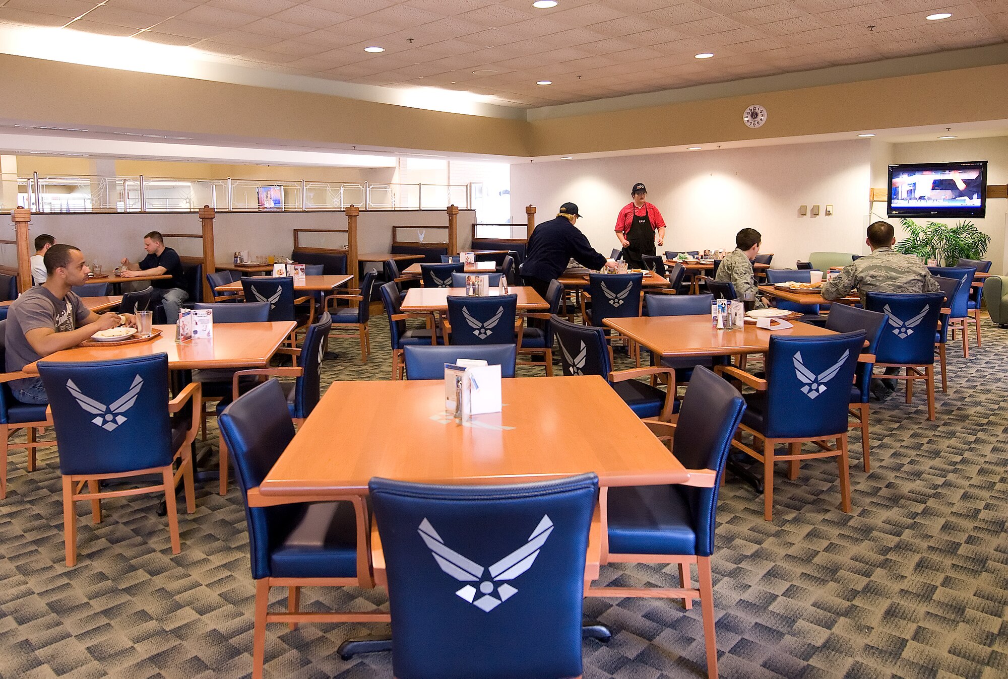 Team Dover members enjoy the new sports pub feel of one of four renovated sections of the Patterson Dining Facility April 12, 2011. All four areas were renovated with different décor. The renovation was completed with more than $350,000 from a Comprehensive Airmen Fitness grant. (U.S. Air Force photo by Adrian Rowan)